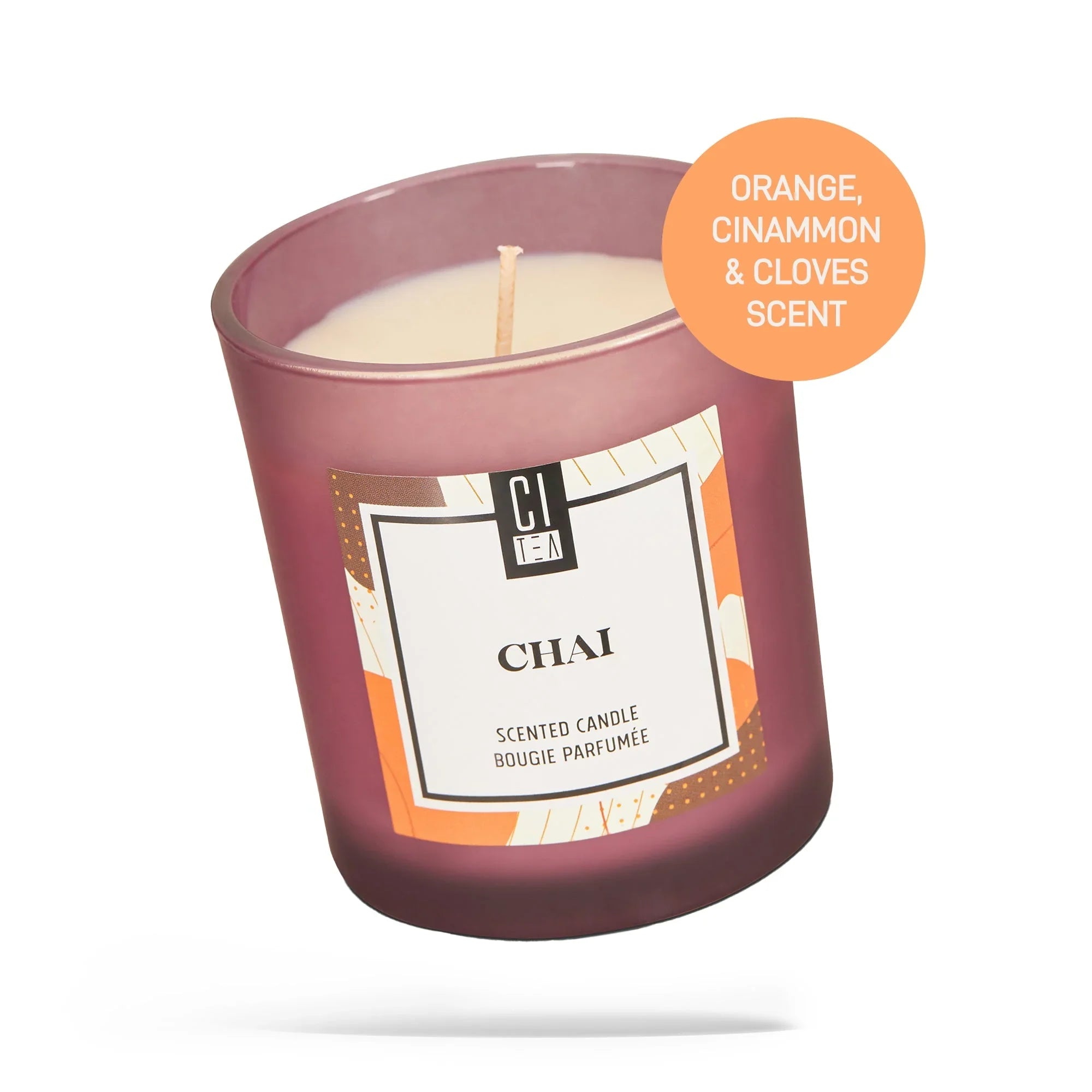 Chai spice soy wax candle in a purple glass jar with orange, cinnamon, and clove scent