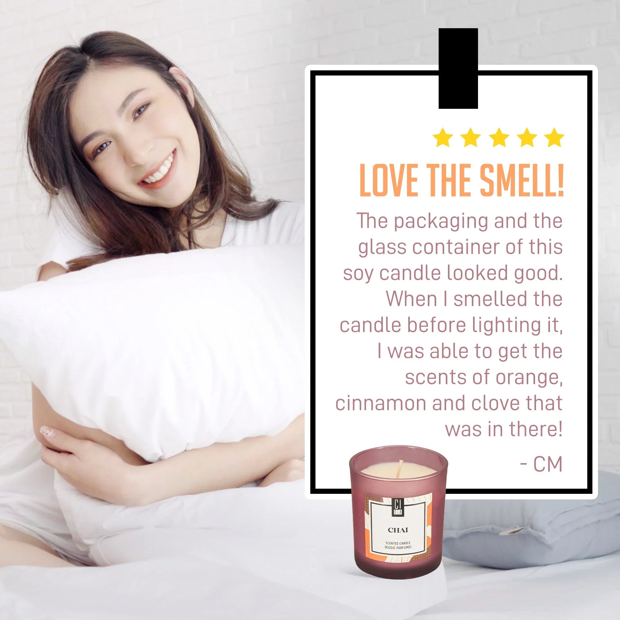 Woman smiling in bed with pillow, chai spice soy wax candle and five-star review displayed.