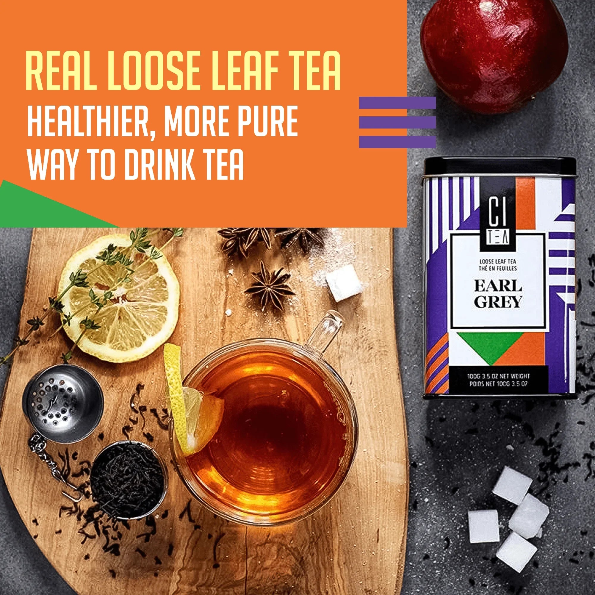 Earl Grey loose leaf tea with glass cup, lemon, sugar cubes, and tea infuser on wooden board