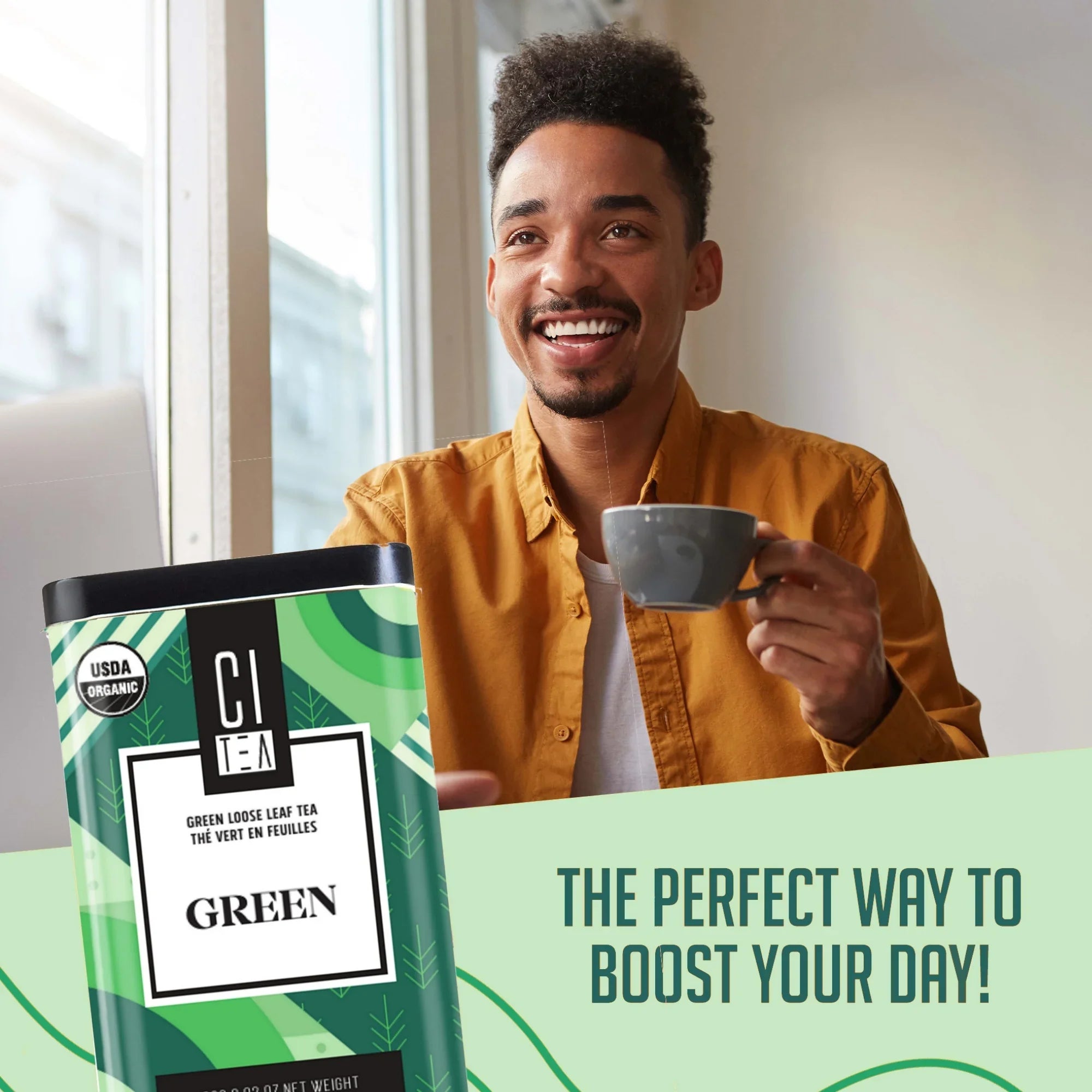 Smiling man enjoying cup of CI Tea green loose leaf tea by window, product can in foreground