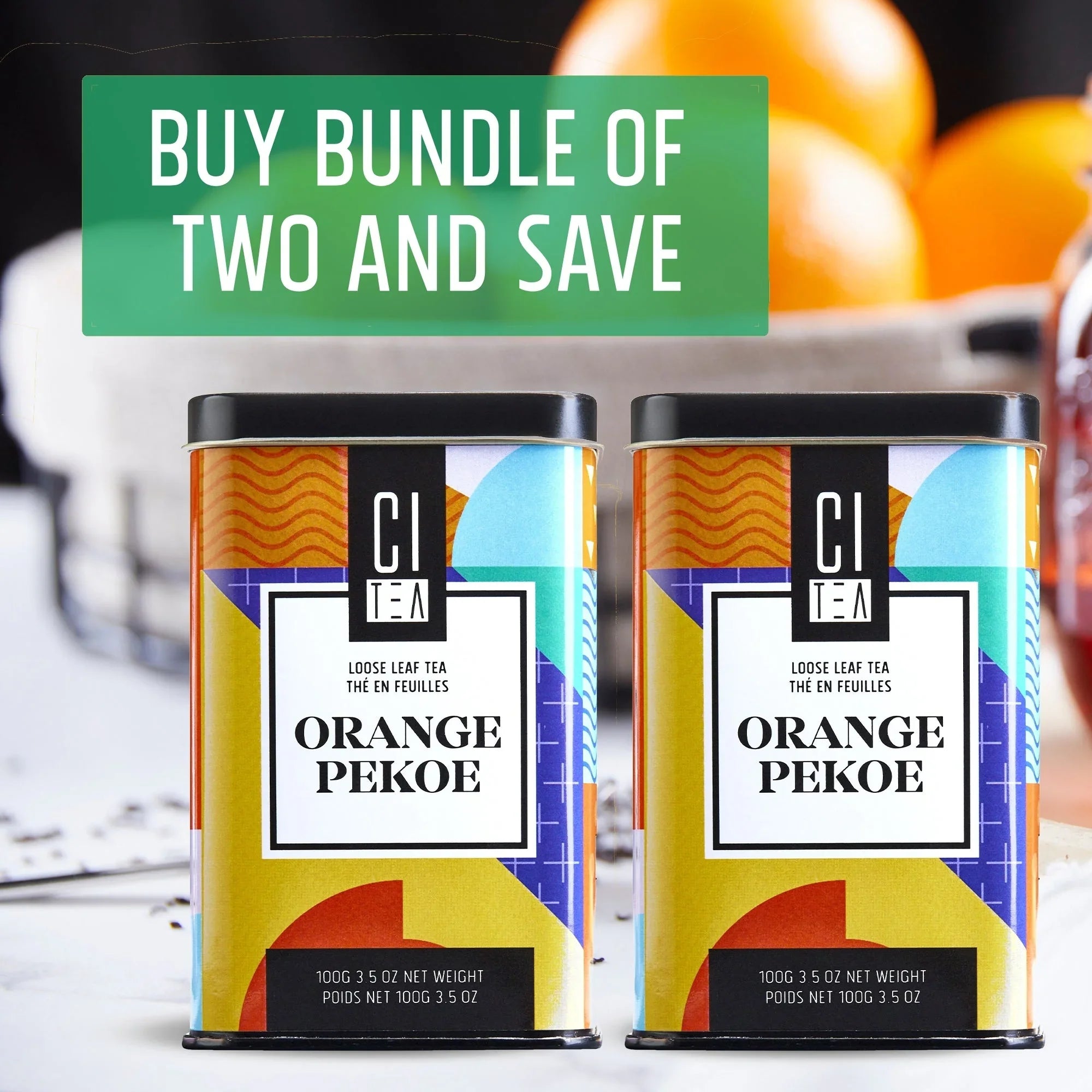 Two tins of Orange Pekoe loose leaf tea bundle offer with oranges in background