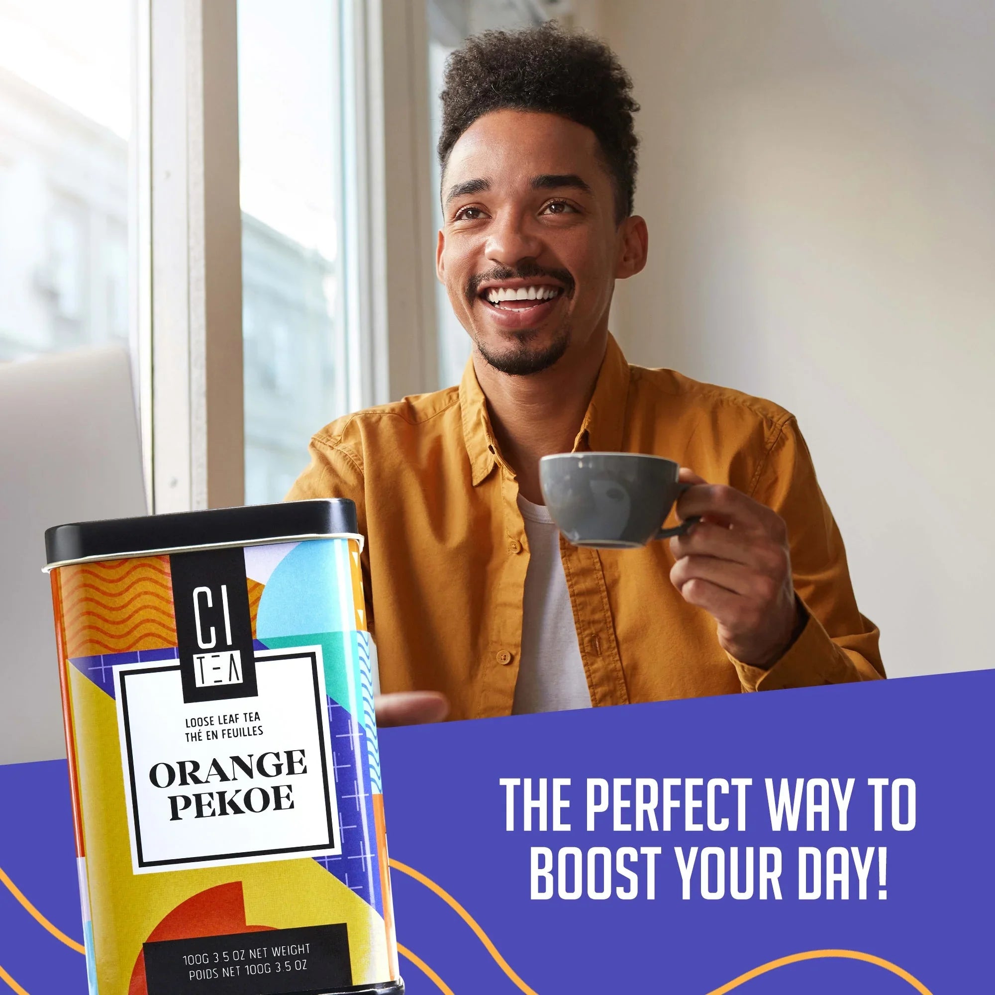 Smiling man enjoying loose leaf Orange Pekoe tea in modern kitchen, CI TEA branding visible