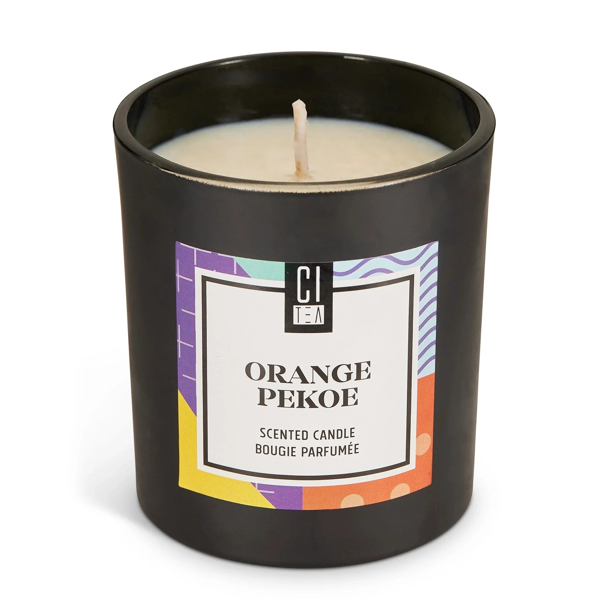 Orange Pekoe soy wax candle in a black jar with colorful label, scented candle product