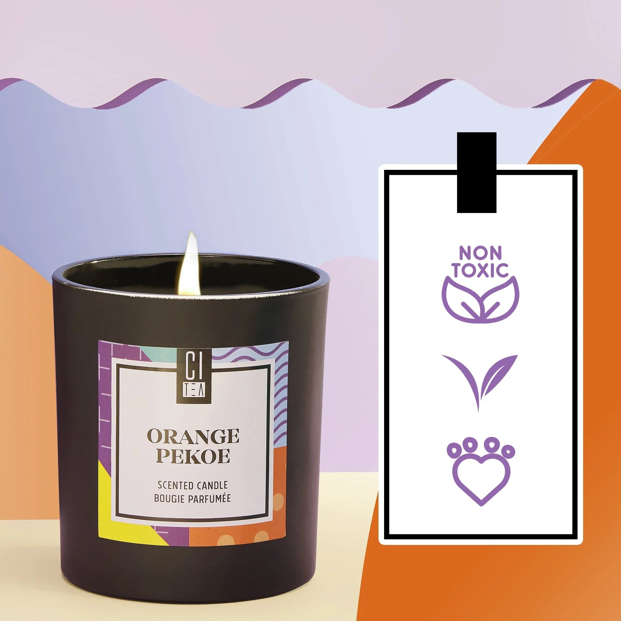 Orange Pekoe soy wax candle in black jar, non-toxic and cruelty-free, colorful background