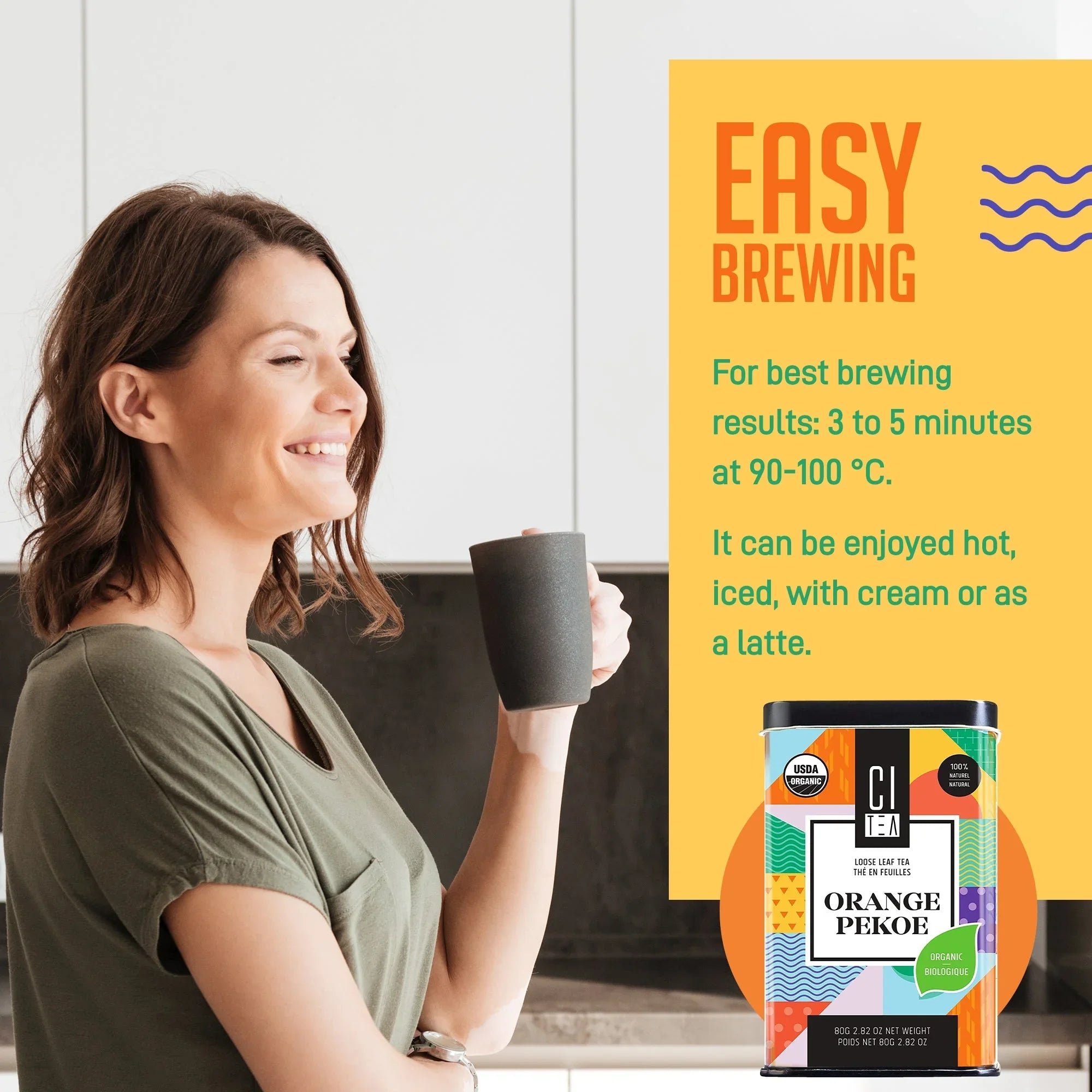 Woman smiling holding mug in kitchen with CI Tea Orange Pekoe organic loose leaf tea and brewing guide.