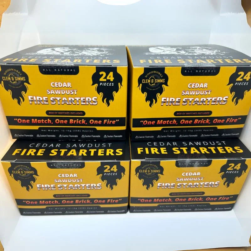 Four boxes of Clem & Simms cedar sawdust fire starters, 24 pieces each, stacked indoors.