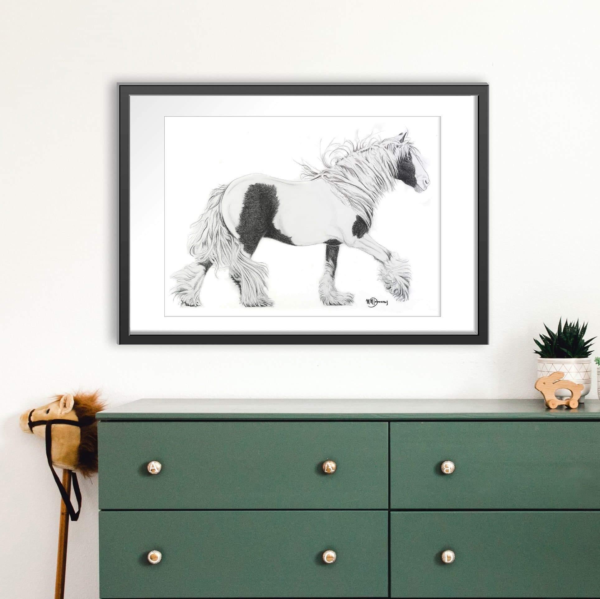 Framed black and white Gypsy cob horse art print above green dresser in modern room