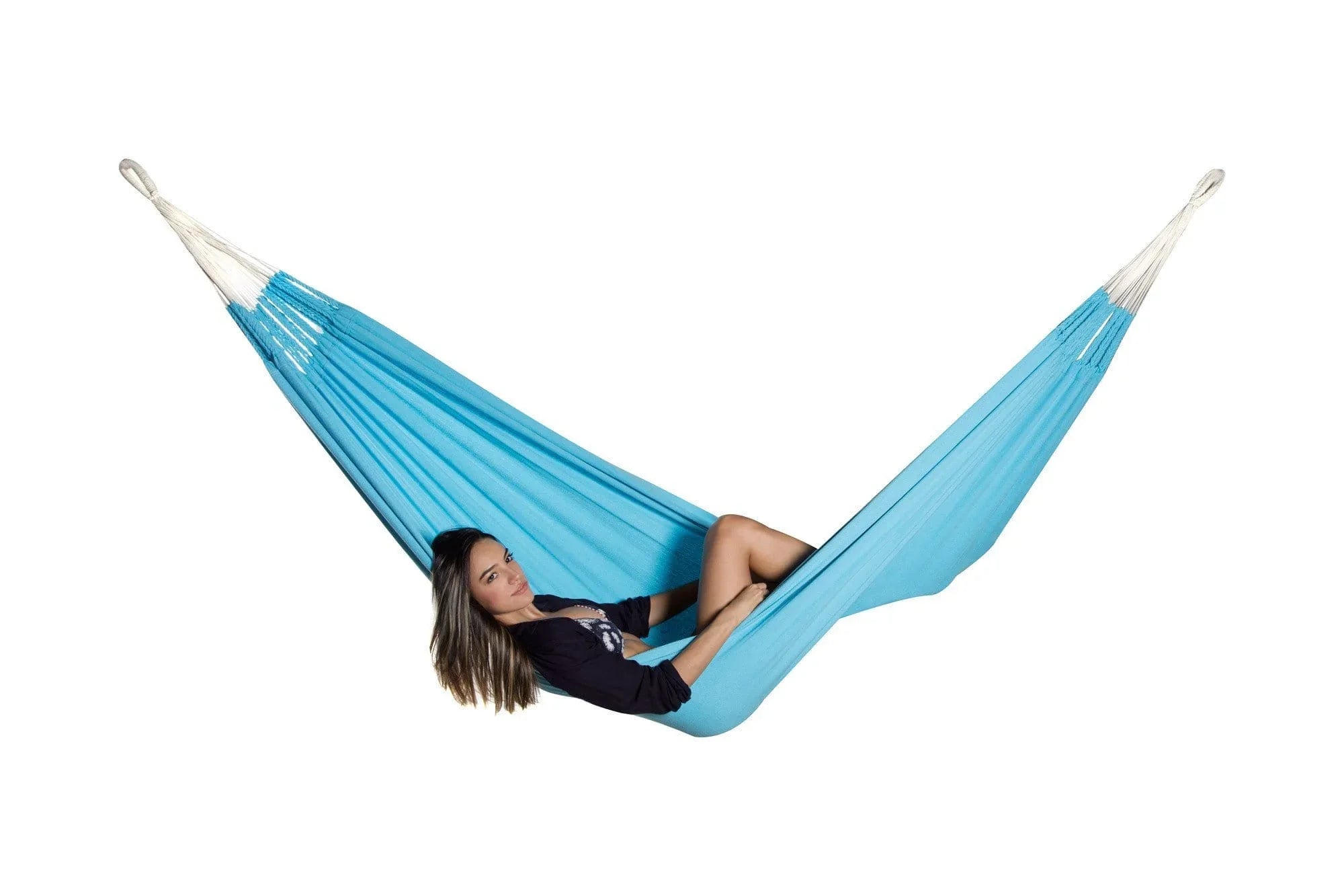 Woman lounging in teal hammock on white background