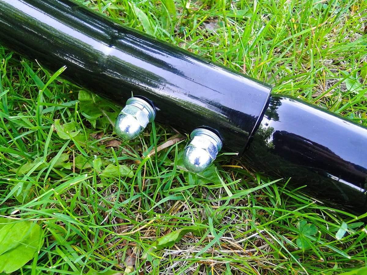 Black metal hammock chair stand connection with bolts on green grass