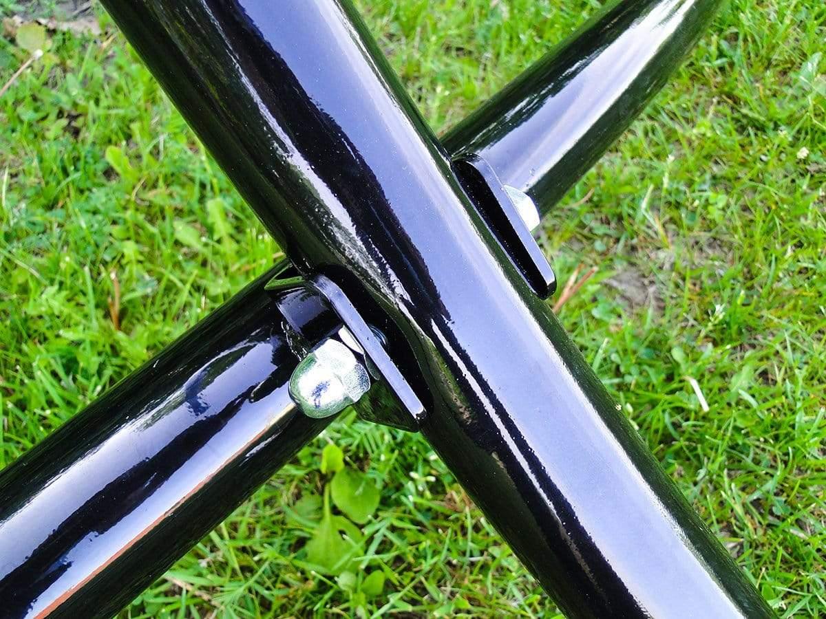 Close-up of black steel hammock chair stand frame and bolt on green grass