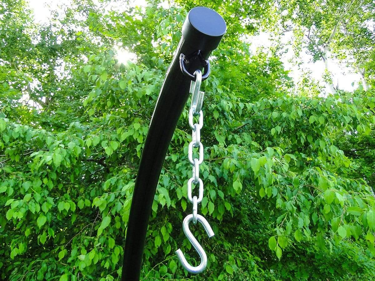 Hammock chair stand with metal chain and S hook outdoors against green leafy trees