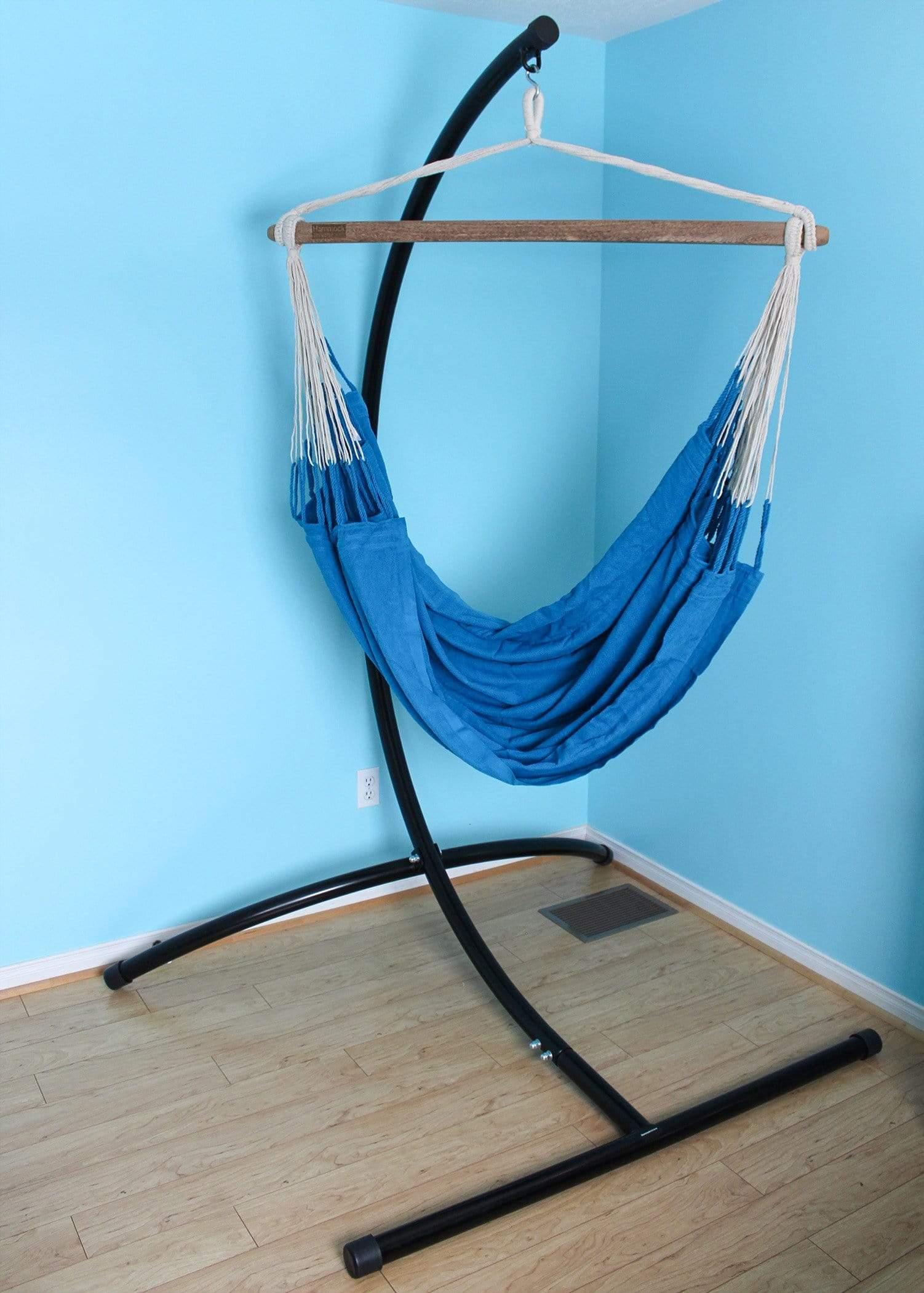 Blue Colombian hammock chair with black metal stand in a light blue room