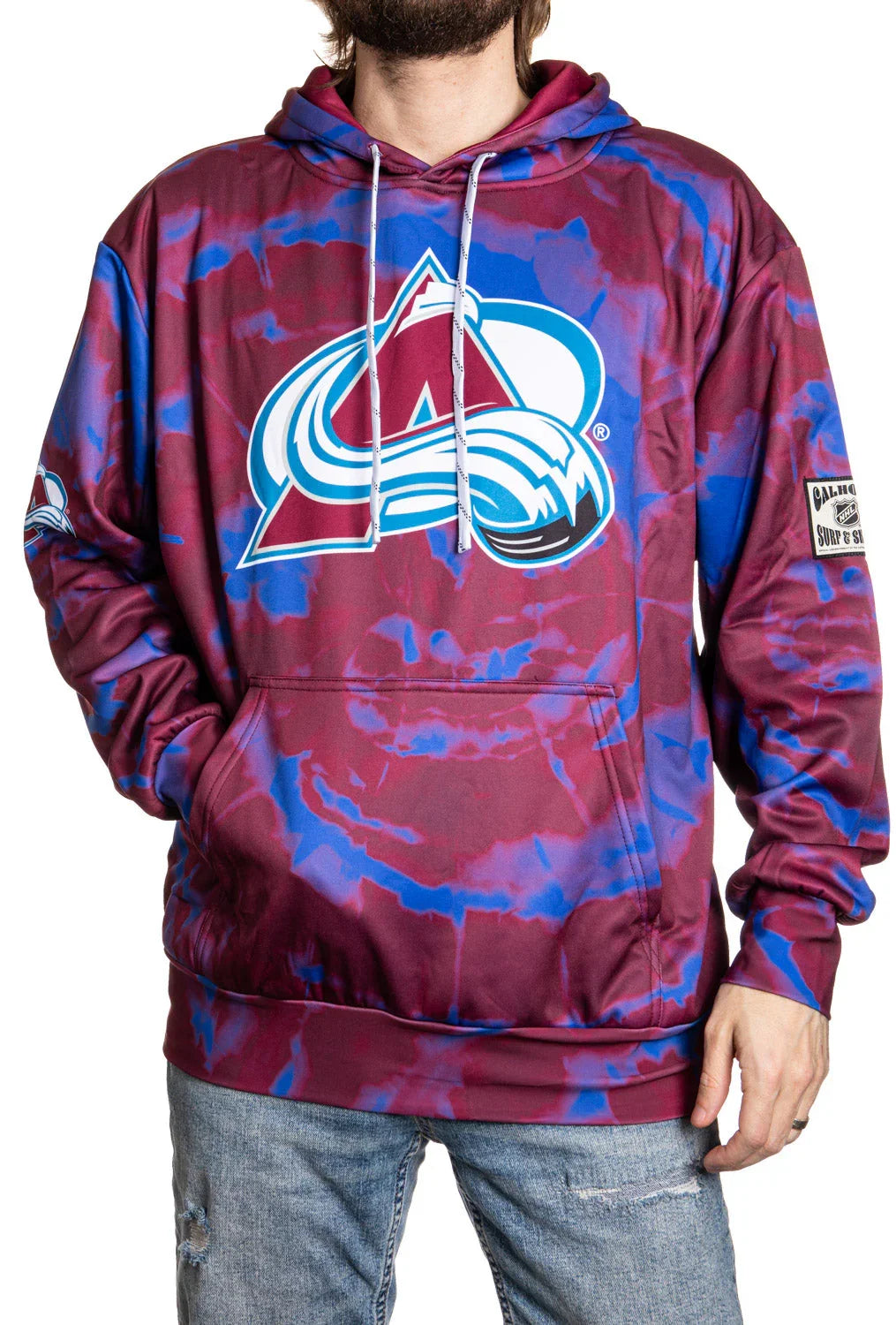 Colorado Avalanche tie-dye sublimated hoodie with large team logo, worn by a man in jeans