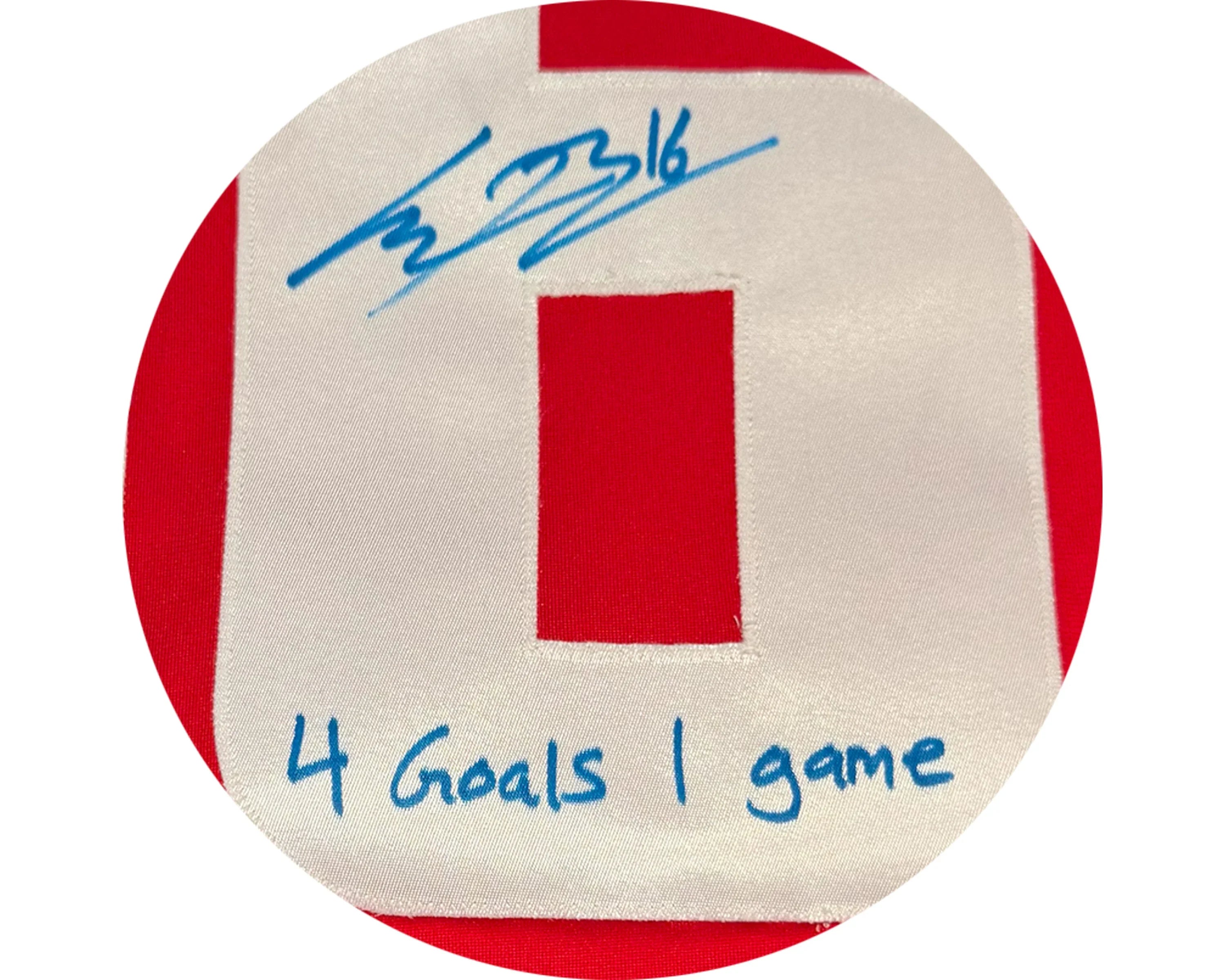 Red and white sports jersey number with blue autograph and '4 Goals 1 game' inscription