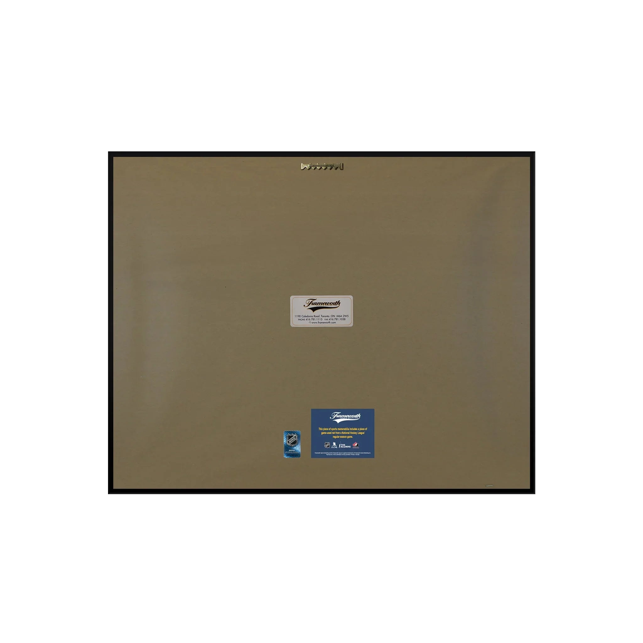 Back of a framed artwork with brown paper backing, labels, and hanging hardware.