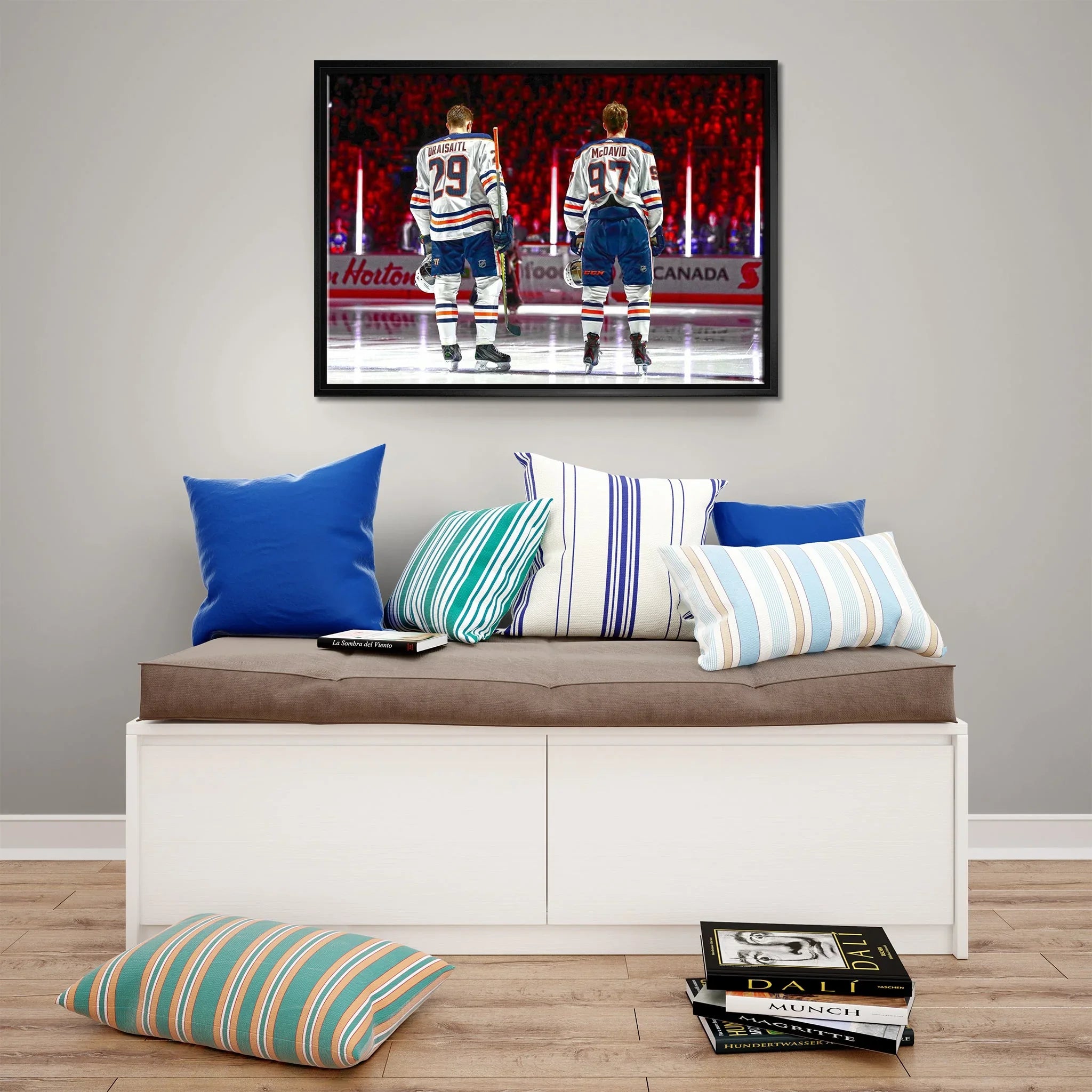 Modern living room with colorful striped pillows and hockey players artwork on wall
