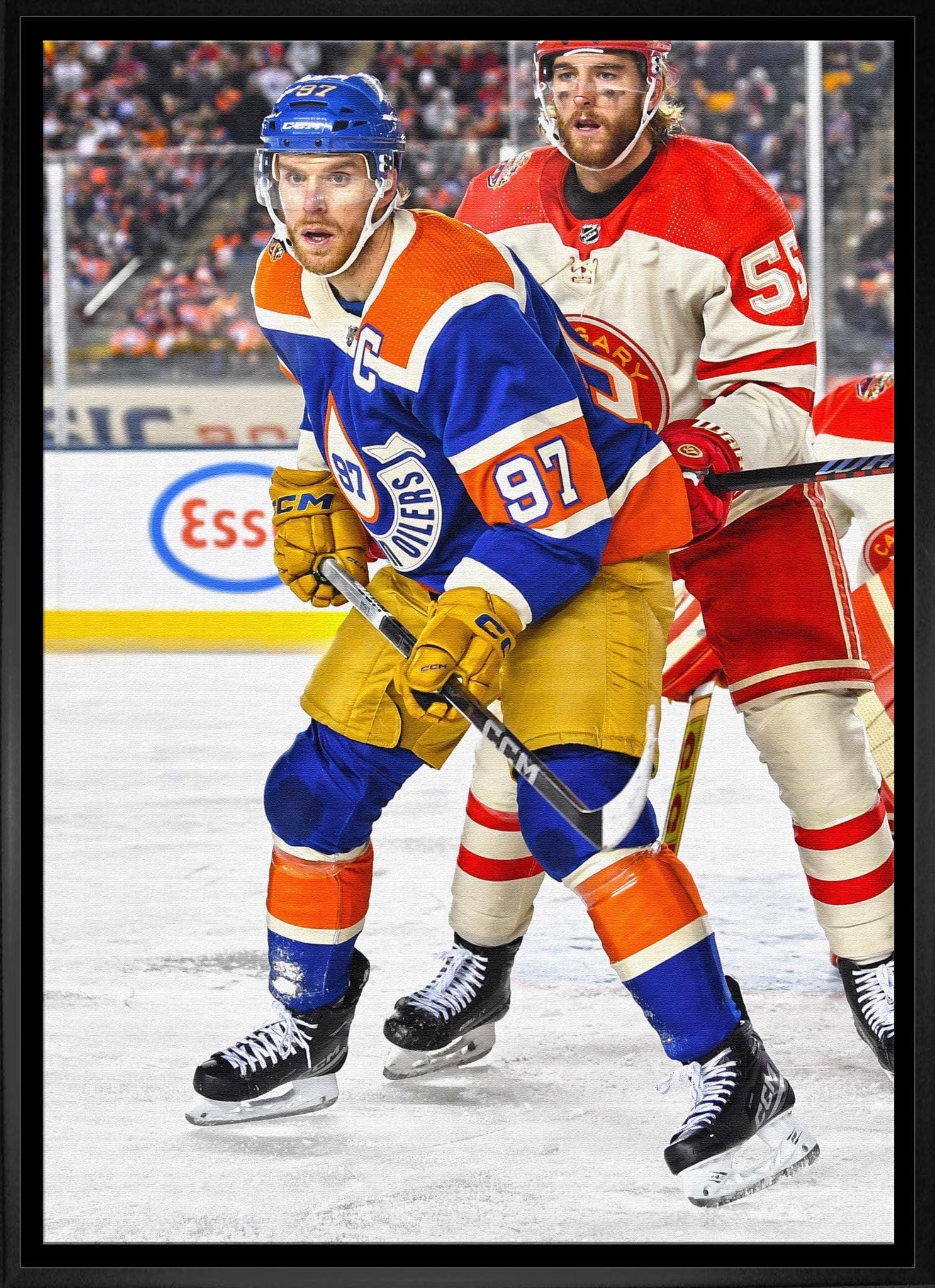 Edmonton Oilers and Calgary Flames hockey players compete during an NHL ice hockey game