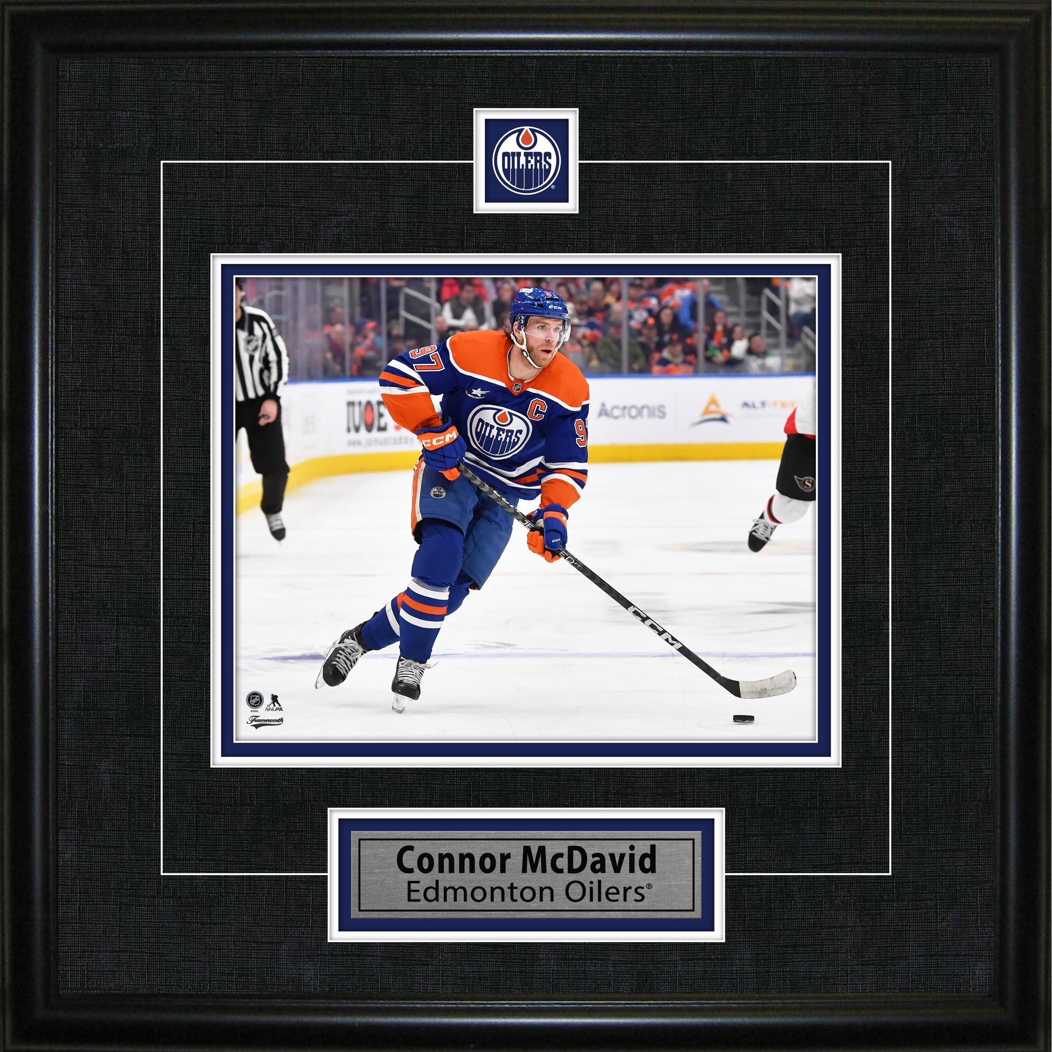 Framed photo of Edmonton Oilers hockey player in action on the ice, labeled Connor McDavid.