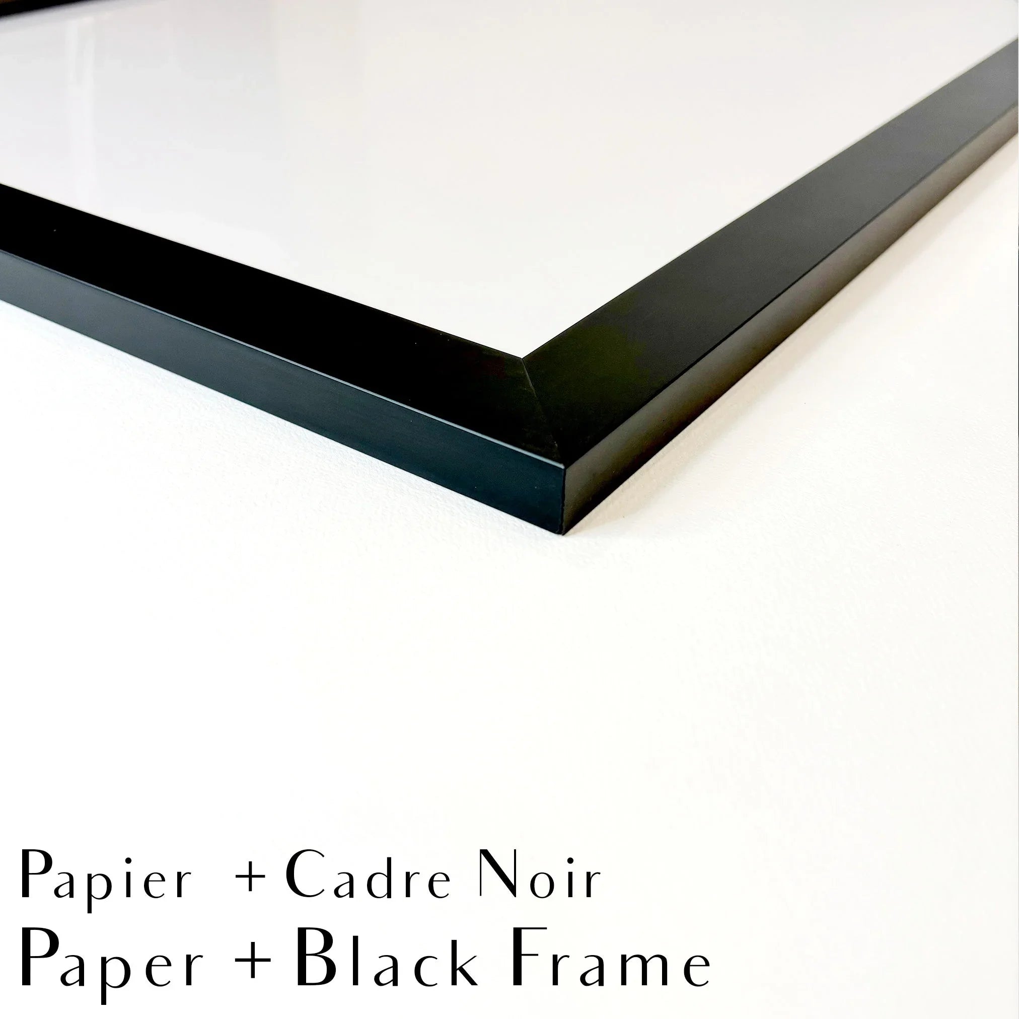 Close-up of a black photo frame corner on white background, paper with black frame