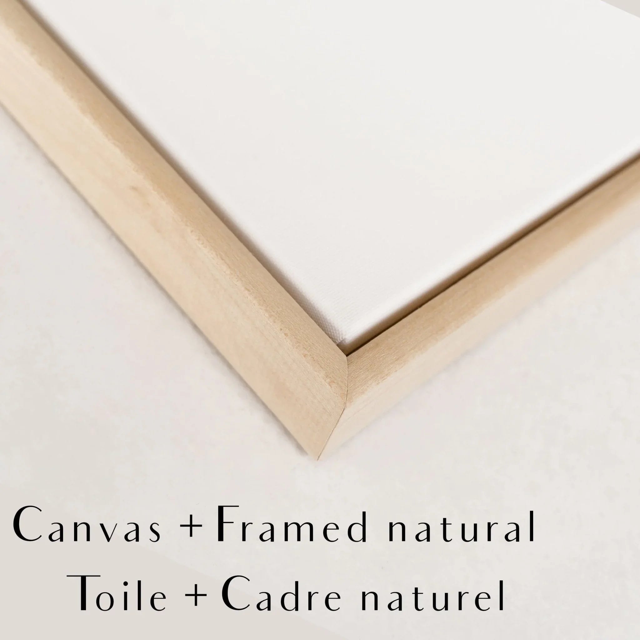 Corner detail of a canvas with a natural wood frame on a light surface