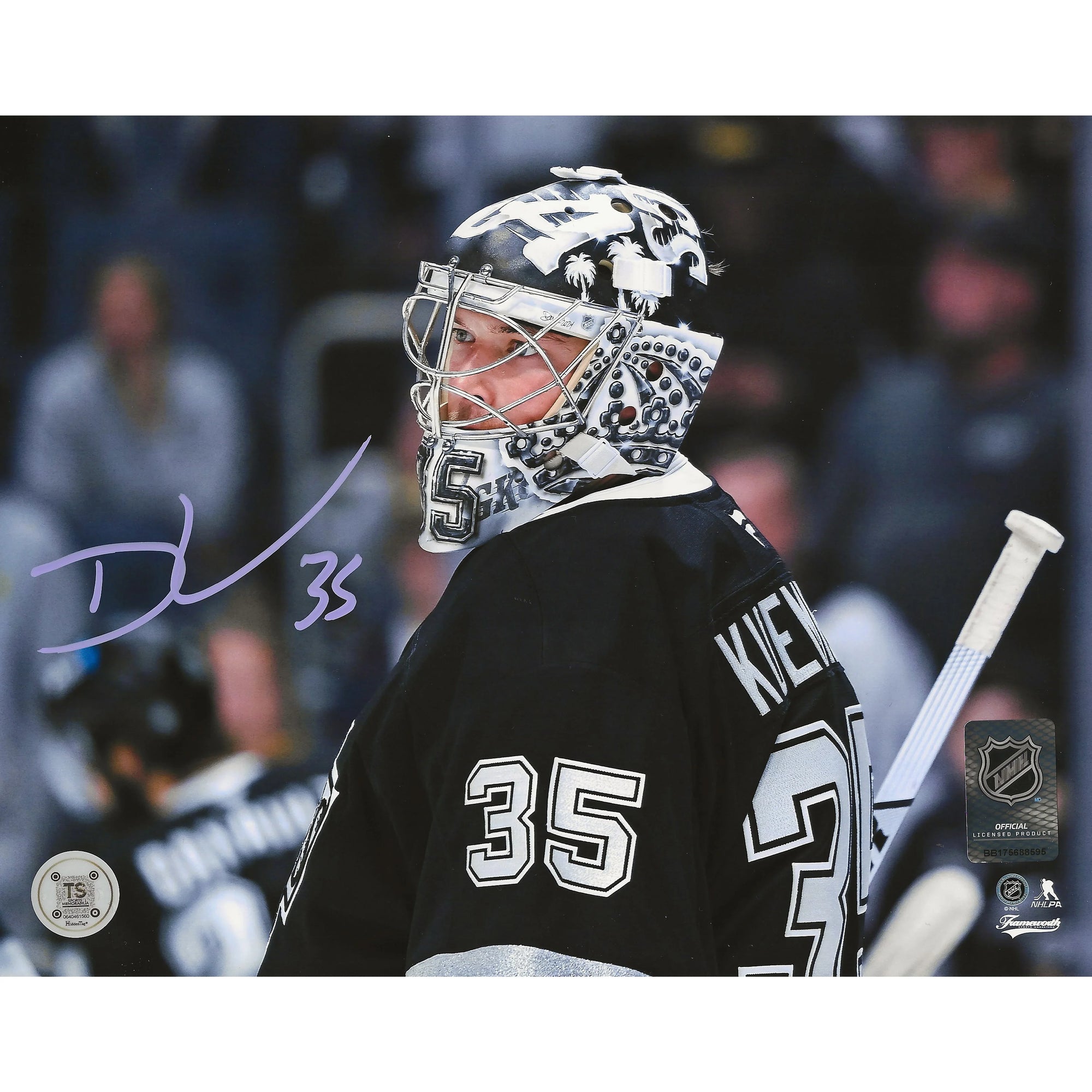 Hockey goalie in black jersey and custom mask on ice, number 35, signed photo