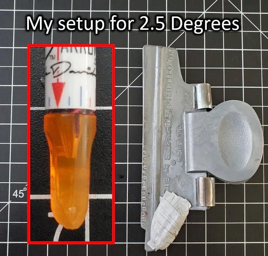 Arrow fletching setup for 2.5 degrees with fletching jig and orange arrow nock on grid mat