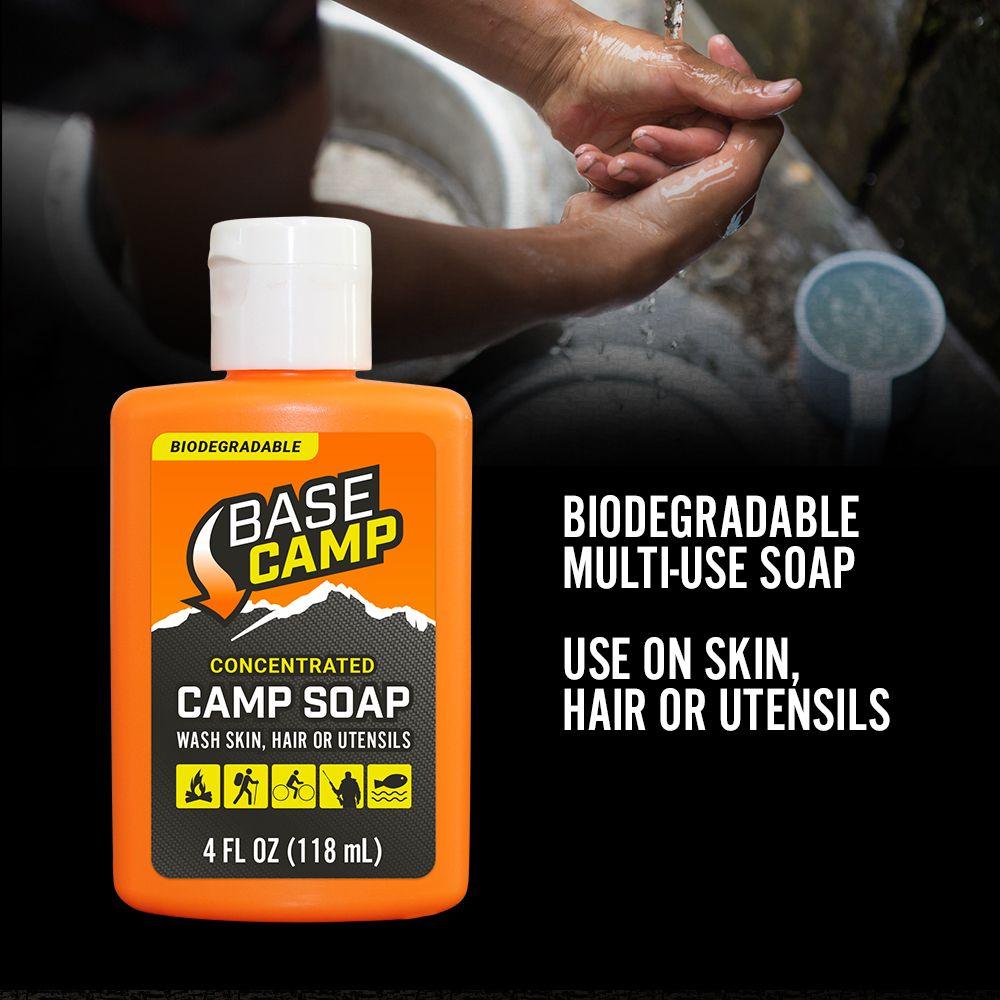 Base Camp biodegradable concentrated camp soap bottle with hands washing outdoors