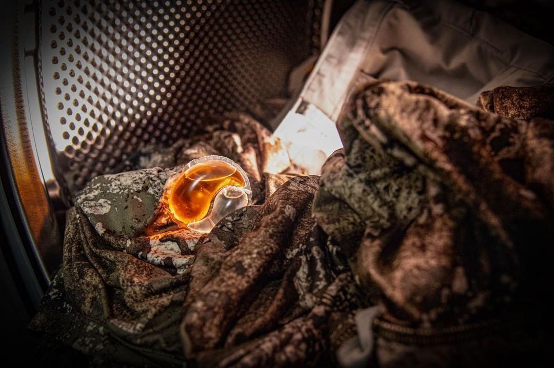 Dead Down Wind Laundry Bomb in washer with camo hunting clothes
