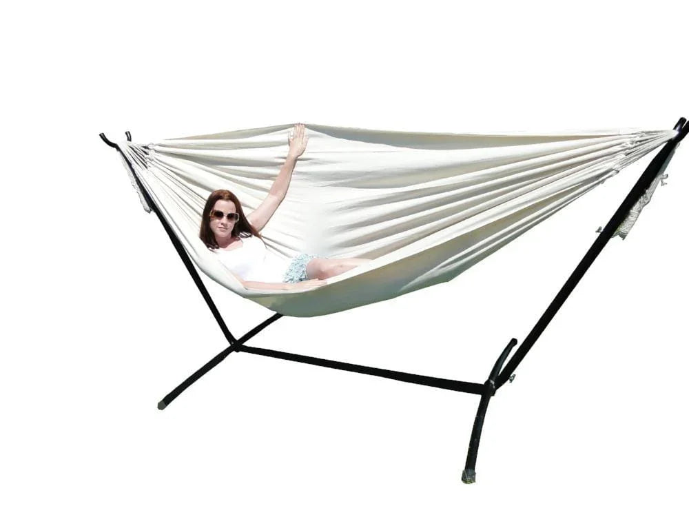 Woman lying in a natural double Brazilian hammock with black universal stand