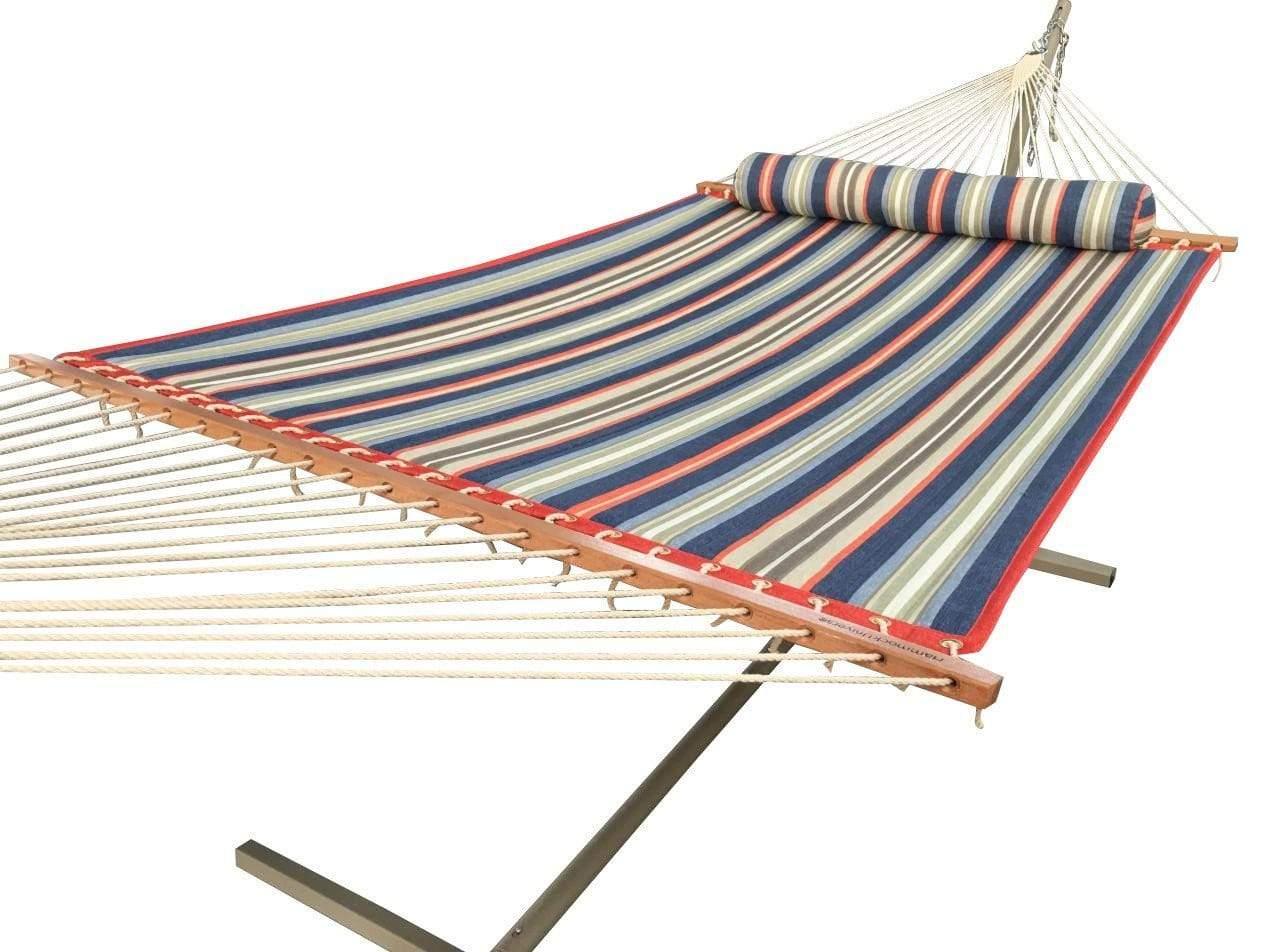 Quilted hammock with red, blue, and green stripes on a metal stand, with pillow