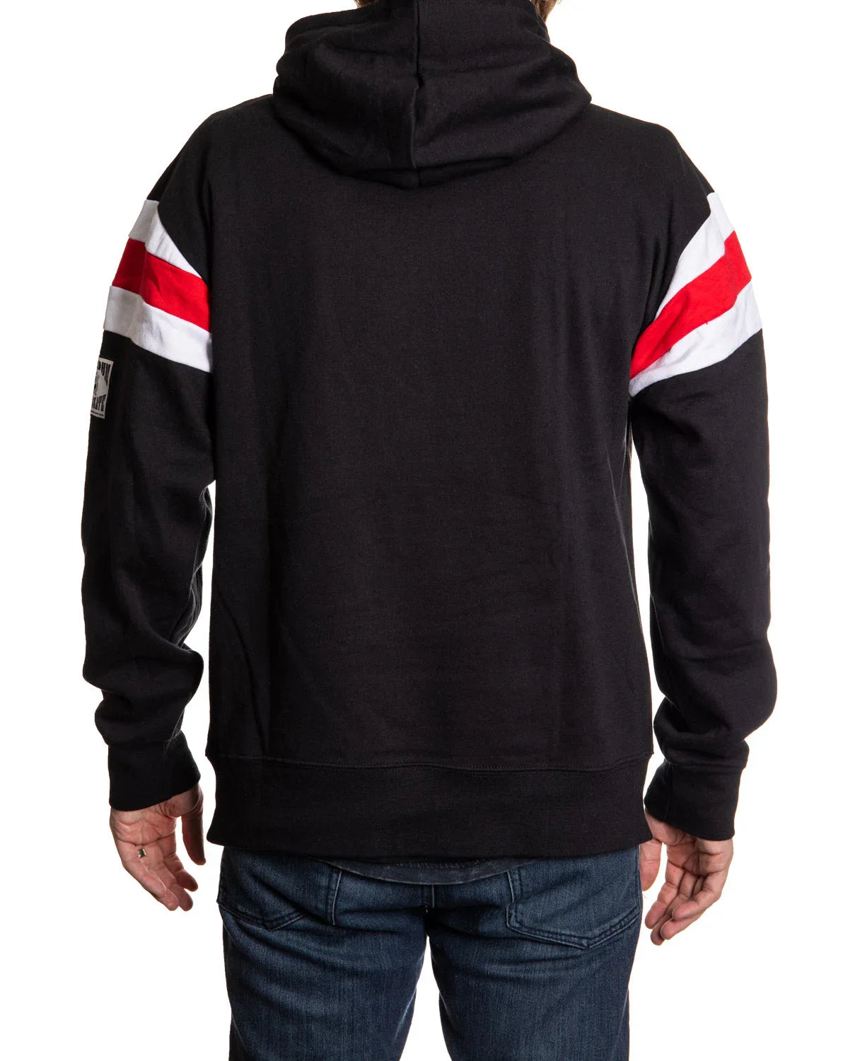 Back view of black Detroit varsity hoodie with red and white sleeve stripes, worn with jeans