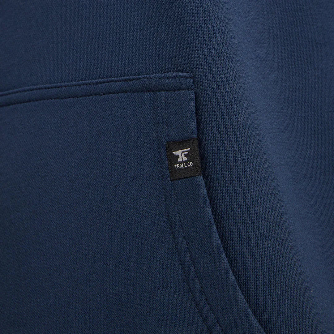 Close-up of navy blue hoodie pocket with Troll Co. logo tag