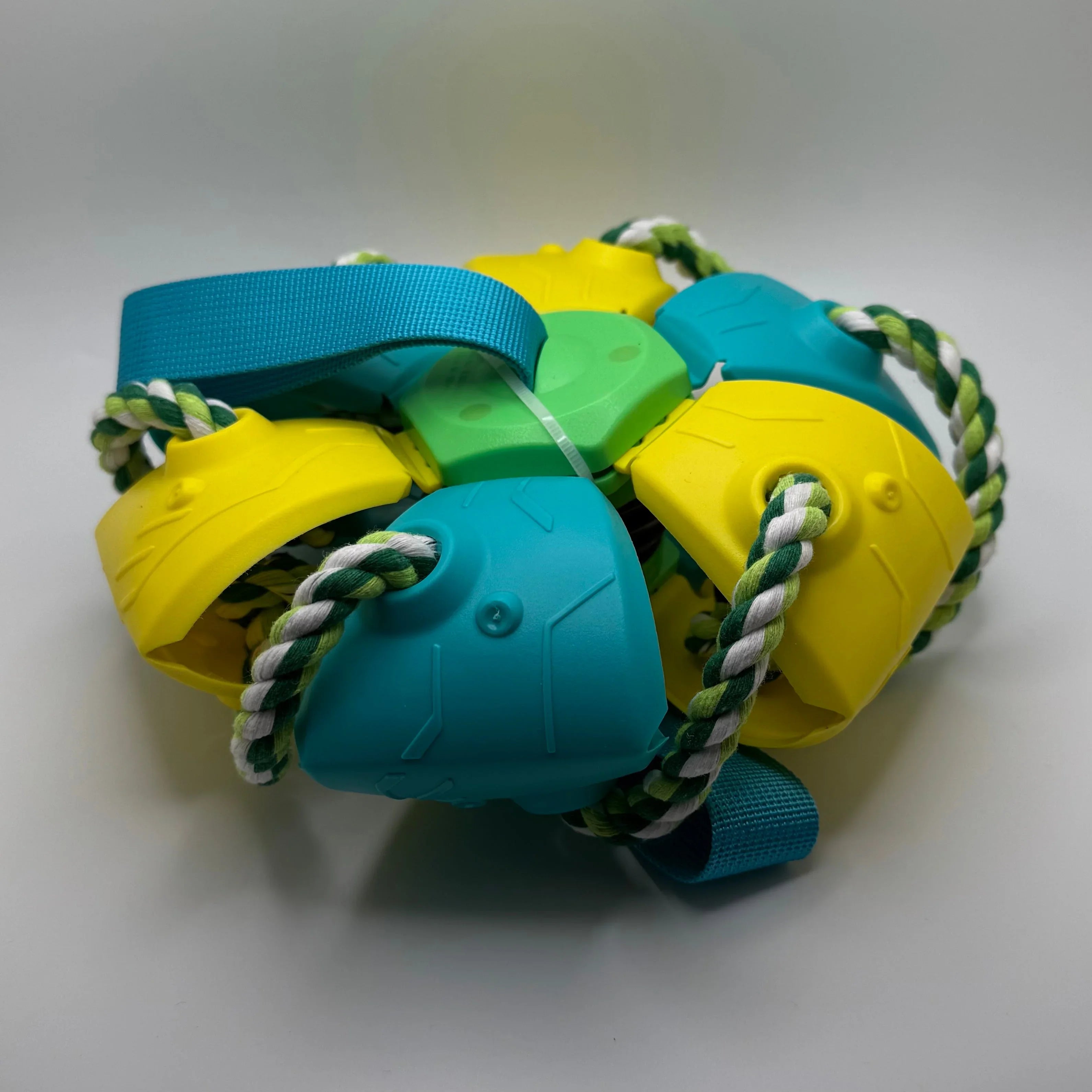 Colorful interactive dog chew toy with blue, yellow, and green plastic and braided rope