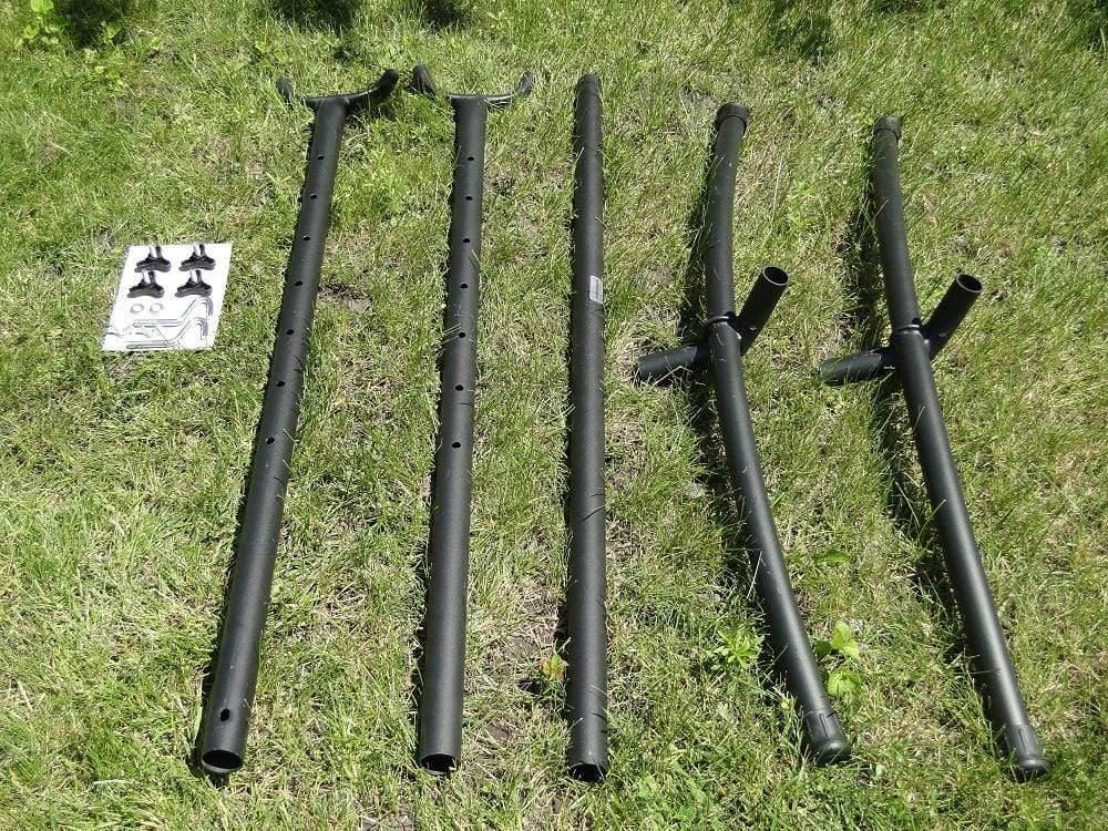Universal hammock stand hardware kit with black metal frame parts on grass