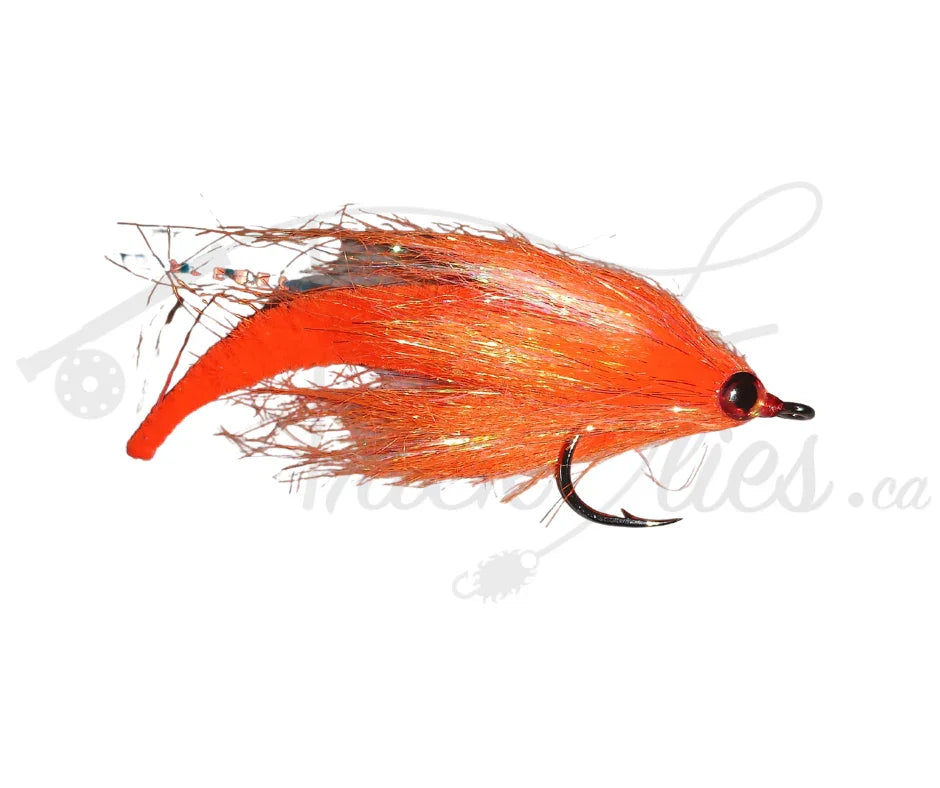 Bright orange dragon tail fishing fly with black hook on white background