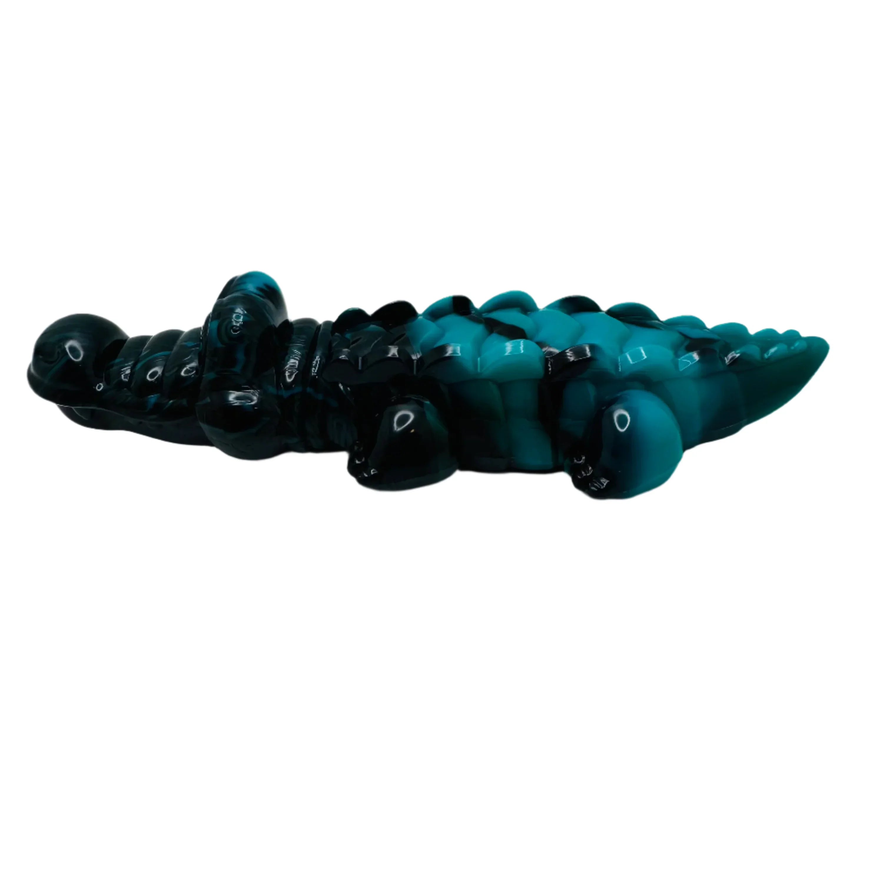 Blue and black segmented crocodile dog toy on white background