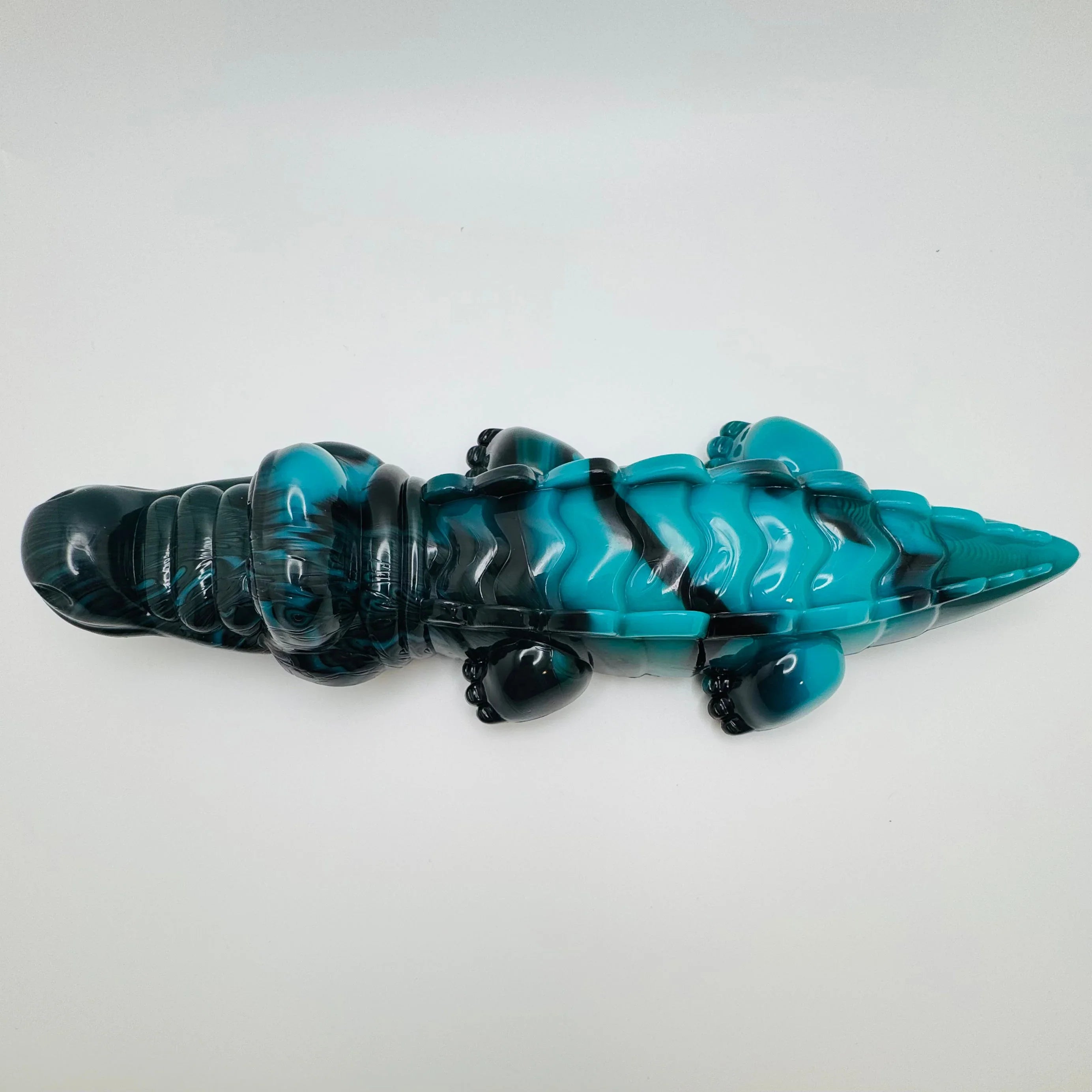 Blue and black alligator dog chew toy on white background, durable pet product