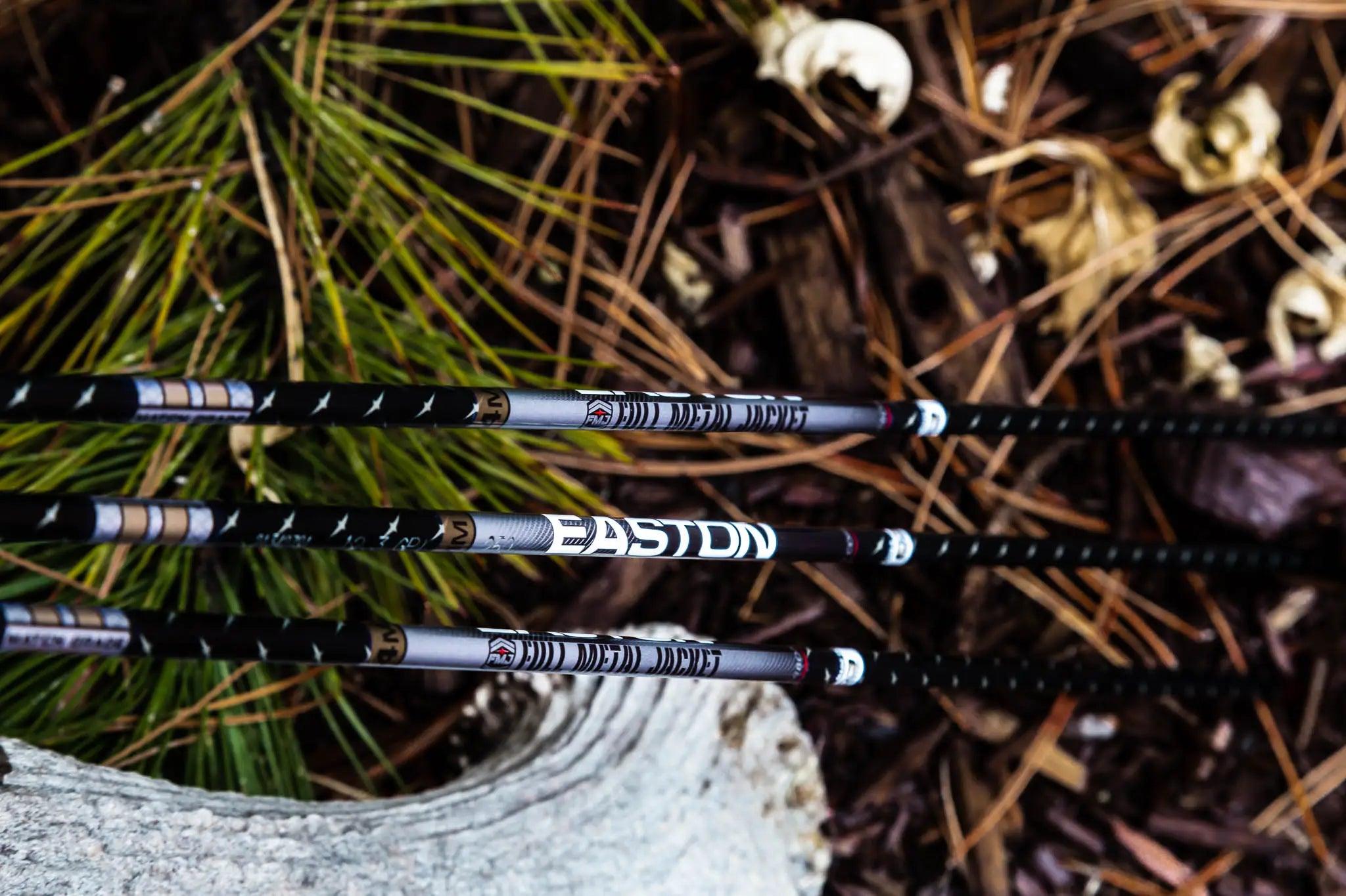 Easton FMJ 4mm carbon arrow shafts outdoors on forest ground with pine needles