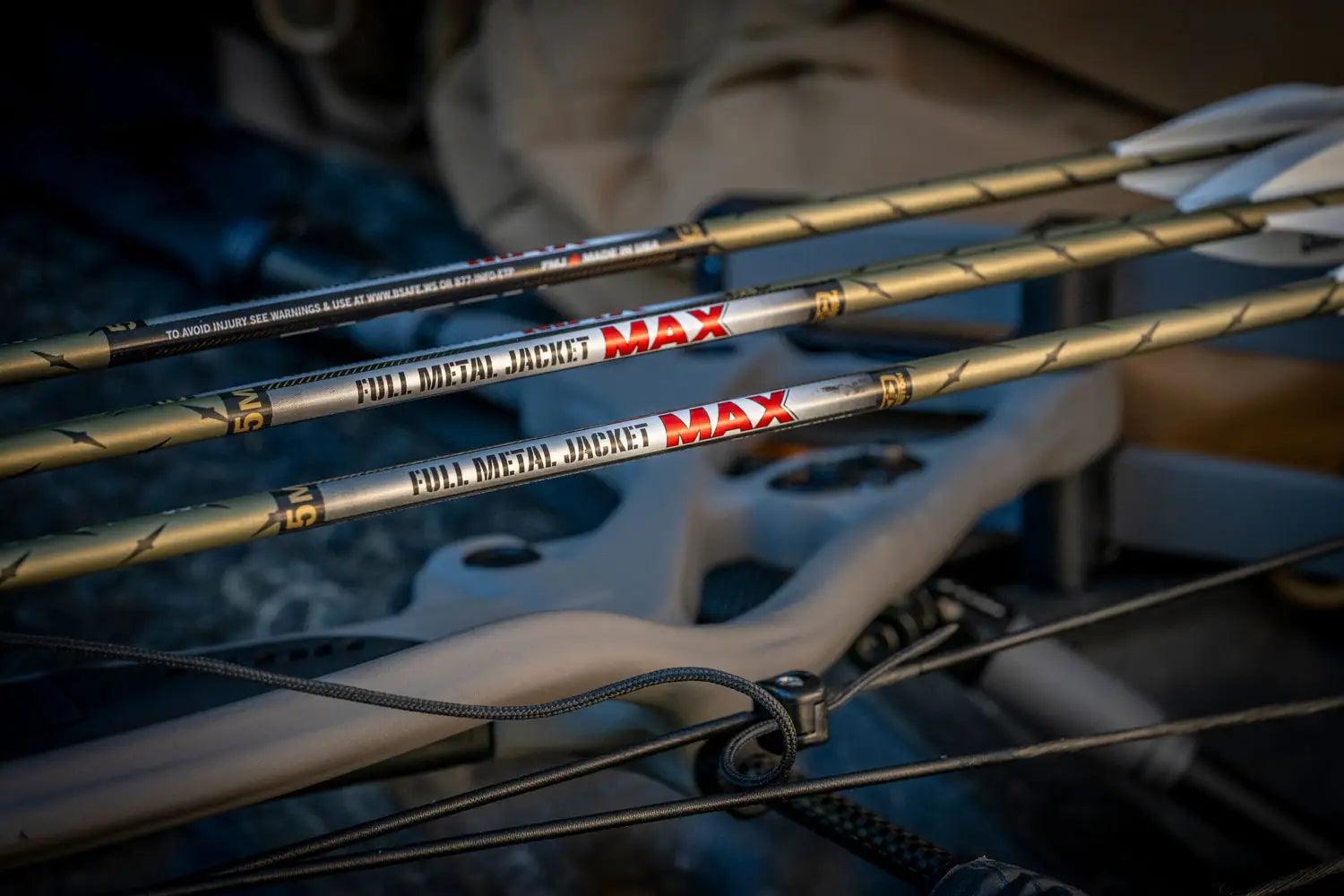 Close-up of three 5MM Full Metal Jacket MAX arrows on a compound bow for archery hunting.
