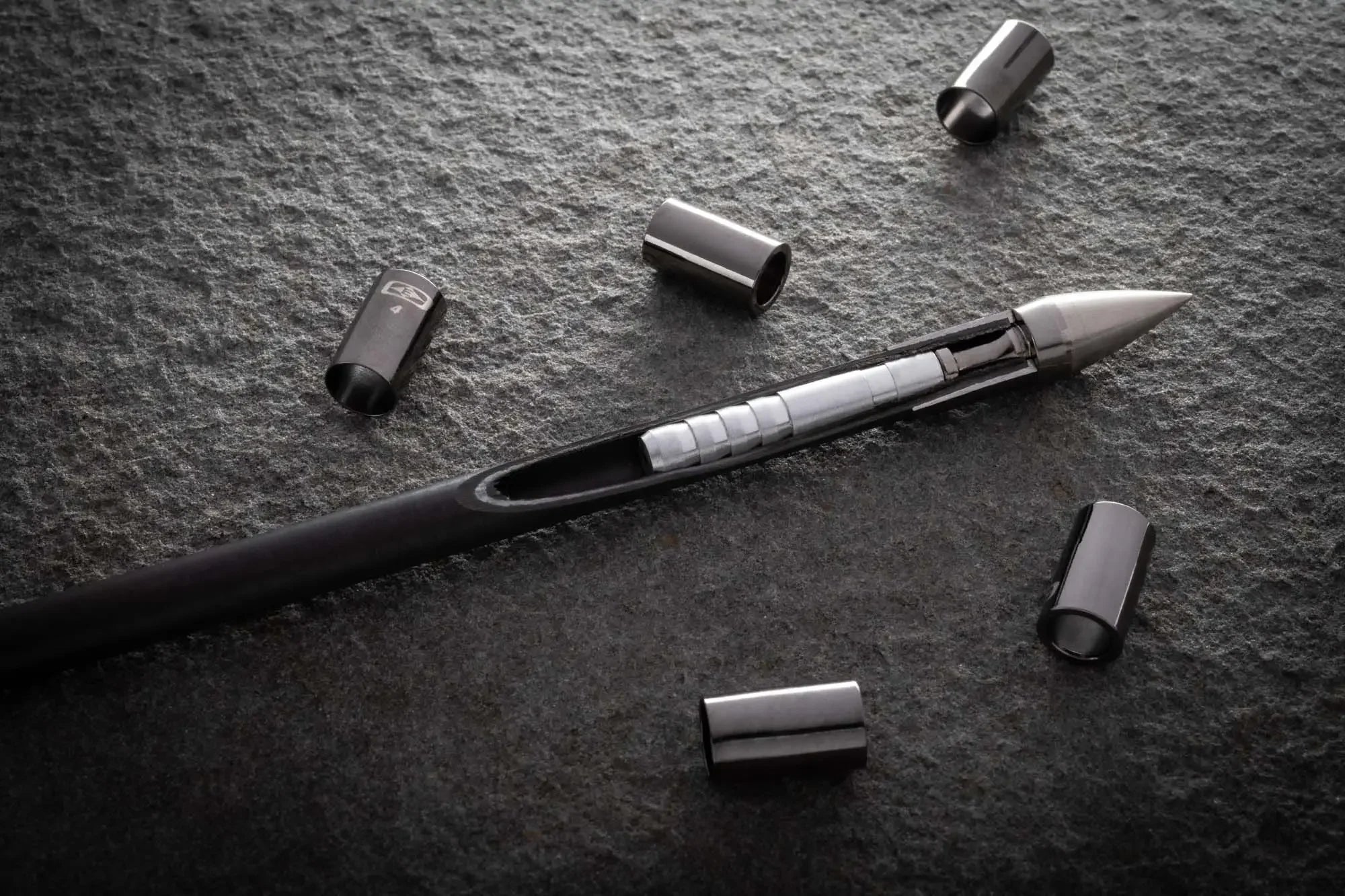 Match Grade Collar titanium arrow collars displayed on textured stone surface