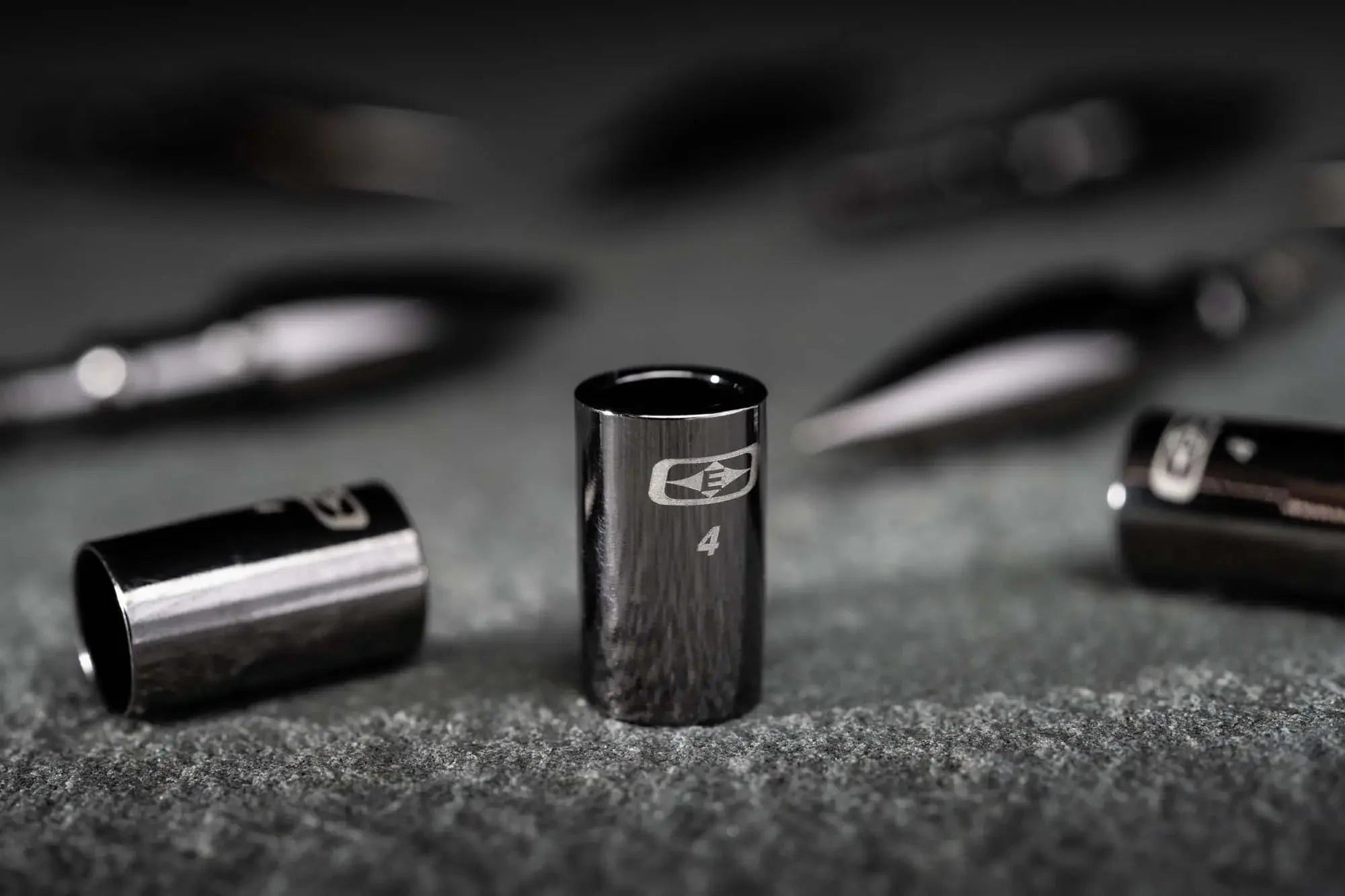 Black match grade collar on textured surface with engraved logo and number 4