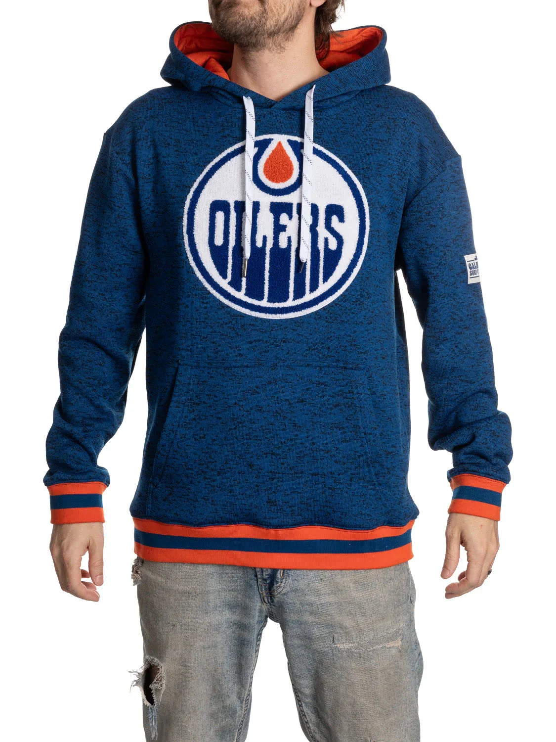 Man wearing blue Edmonton Oilers hoodie with large team logo, orange accents