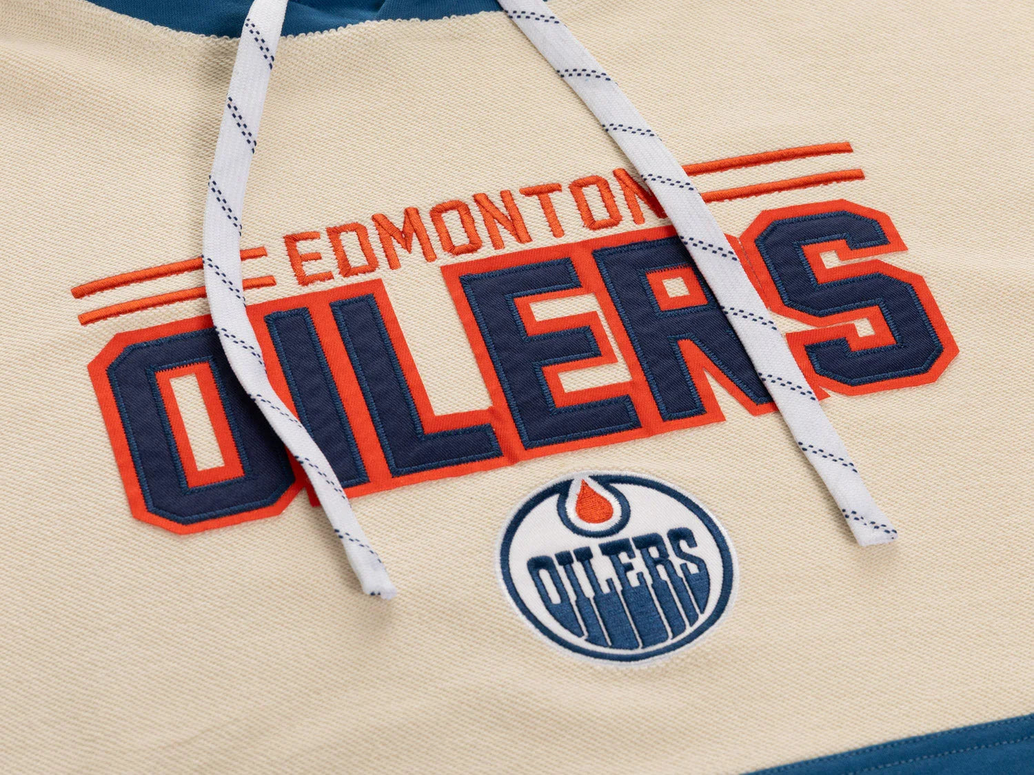 Edmonton Oilers logo and text on beige hockey hoodie with drawstrings