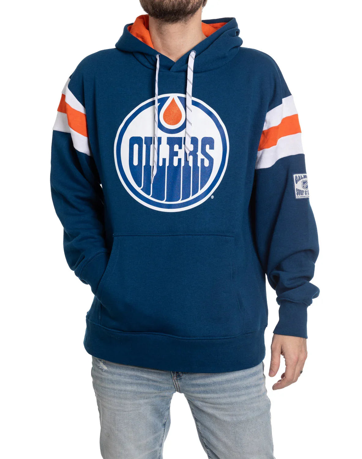 Man wearing blue Edmonton Oilers varsity hoodie with team logo and striped sleeves