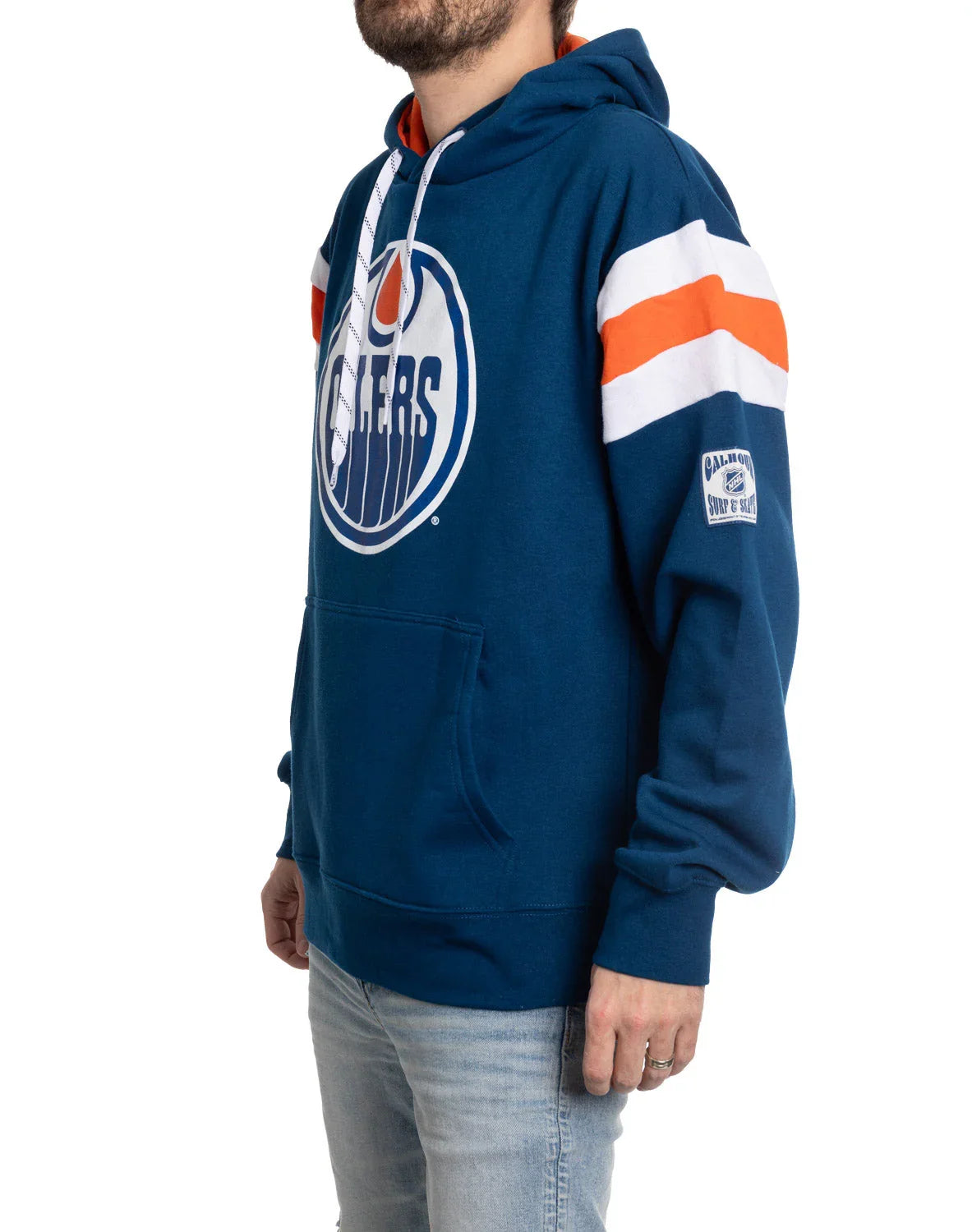 Man wearing blue Edmonton Oilers varsity hoodie with white and orange sleeve stripes