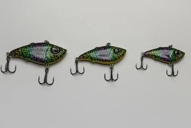 Three colorful fish-shaped fishing lures with treble hooks on a white background