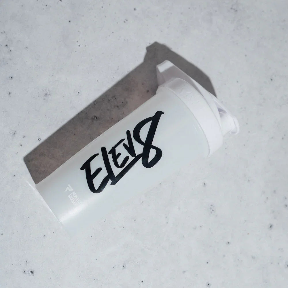 White protein shaker bottle with black ELEV8 logo on marble surface