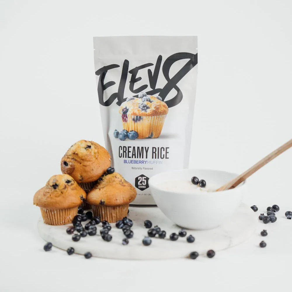 ELEV8 Creamy Rice Blueberry Muffin mix with muffins, blueberries, and a bowl of rice cereal