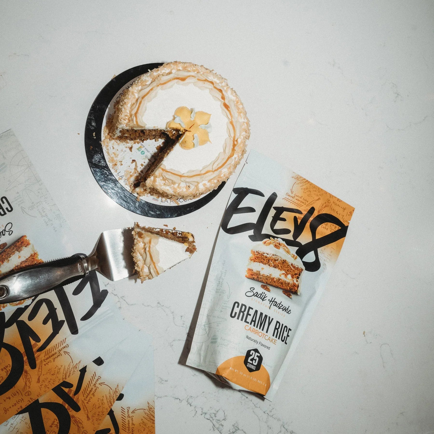 Carrot cake slice next to Sadie Haden Elev8 Creamy Rice Carrot Cake protein powder