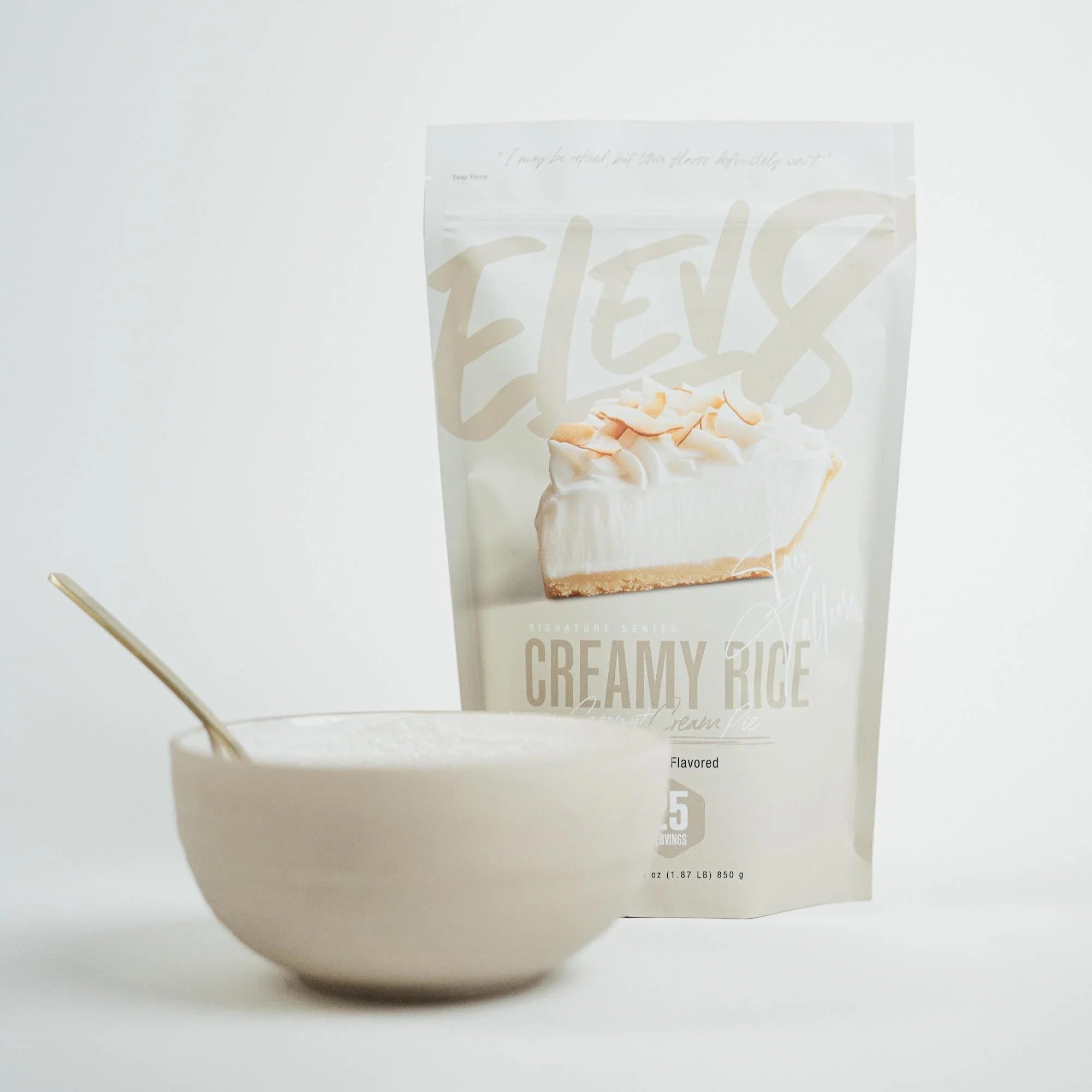 Elev8 Creamy Rice Coconut Cream Pie flavored protein mix with a bowl of prepared rice cereal